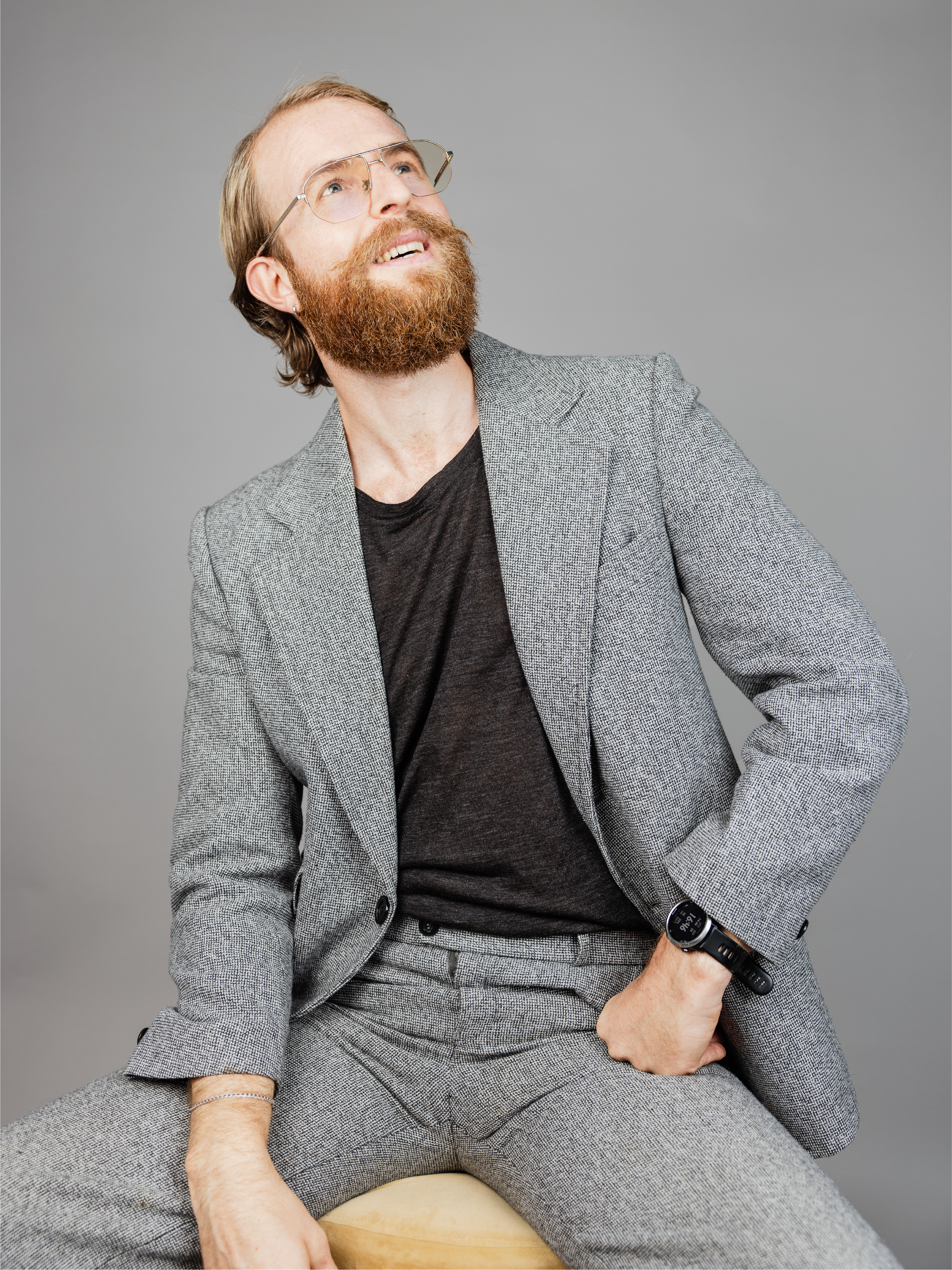 Man with glasses looking upwards