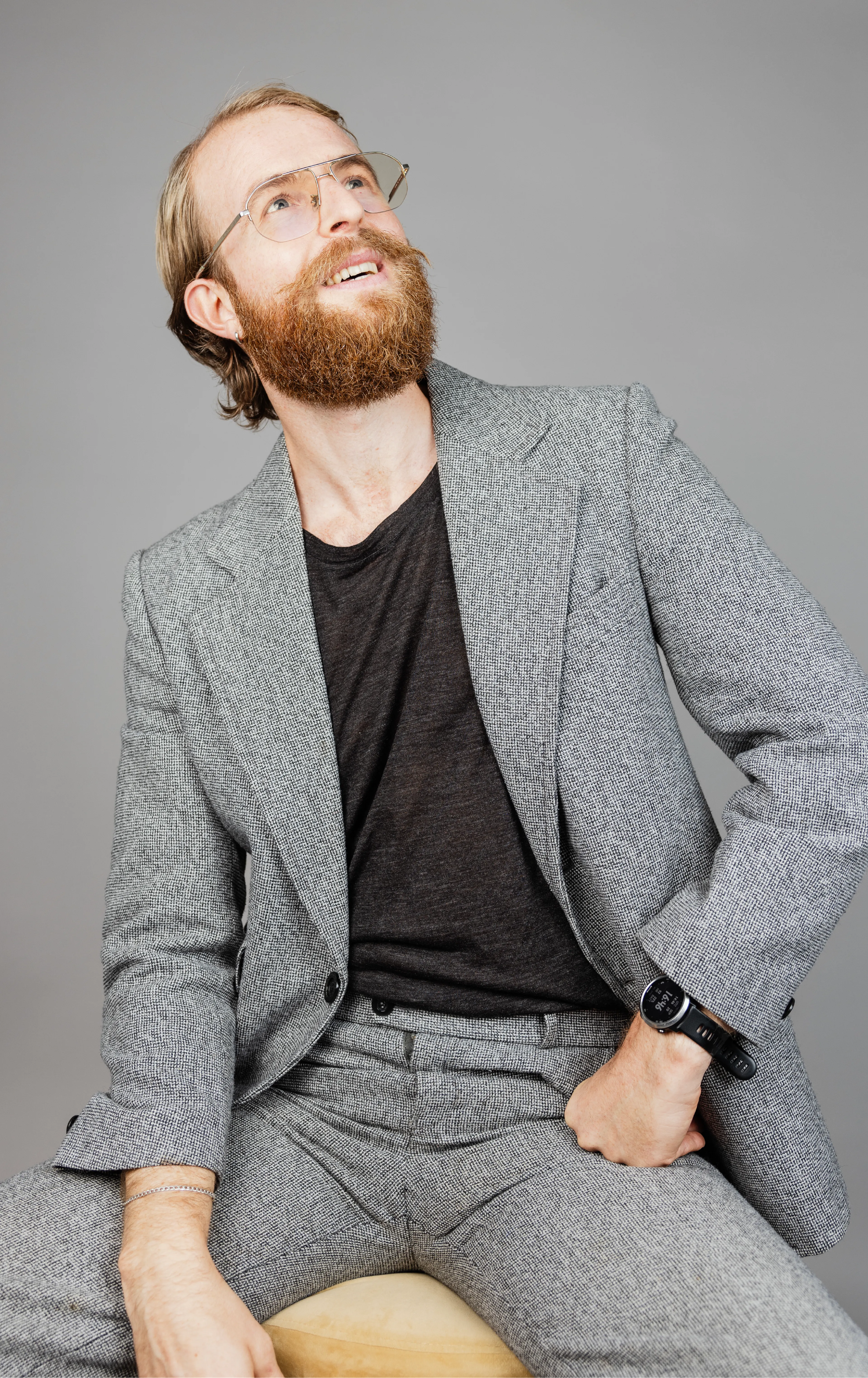 Man with glasses looking upwards