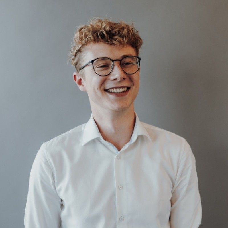 Smiling Man with glasses wearing a white shirt