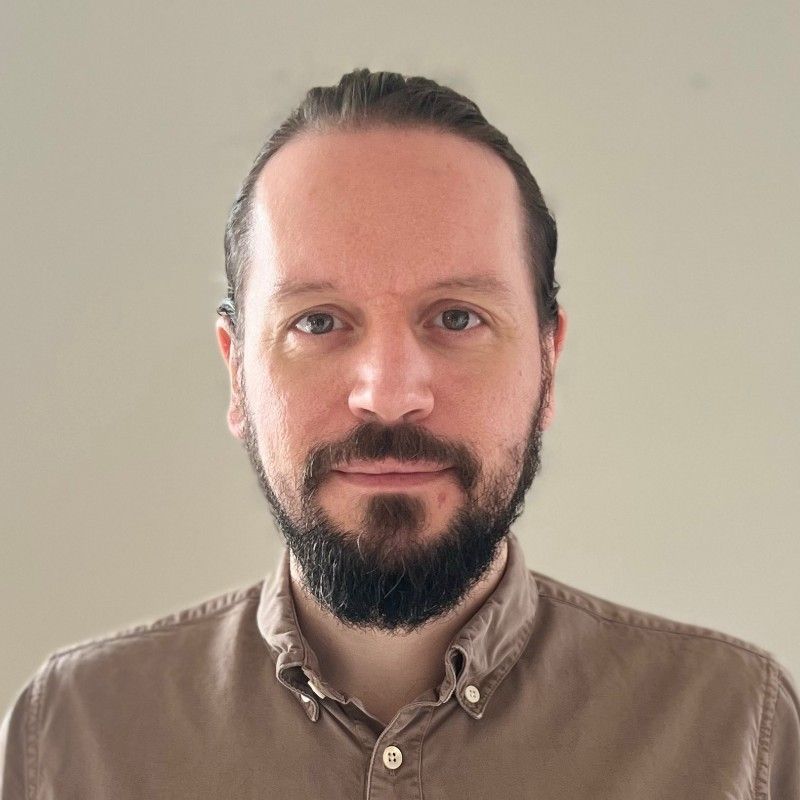 Image of male consultant wearing a brown blouse