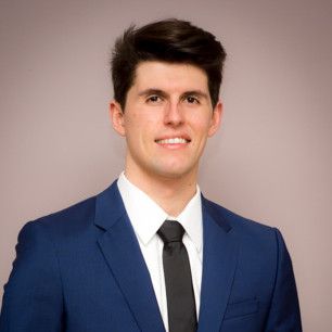 Image of a man in a blue suit, dark hair