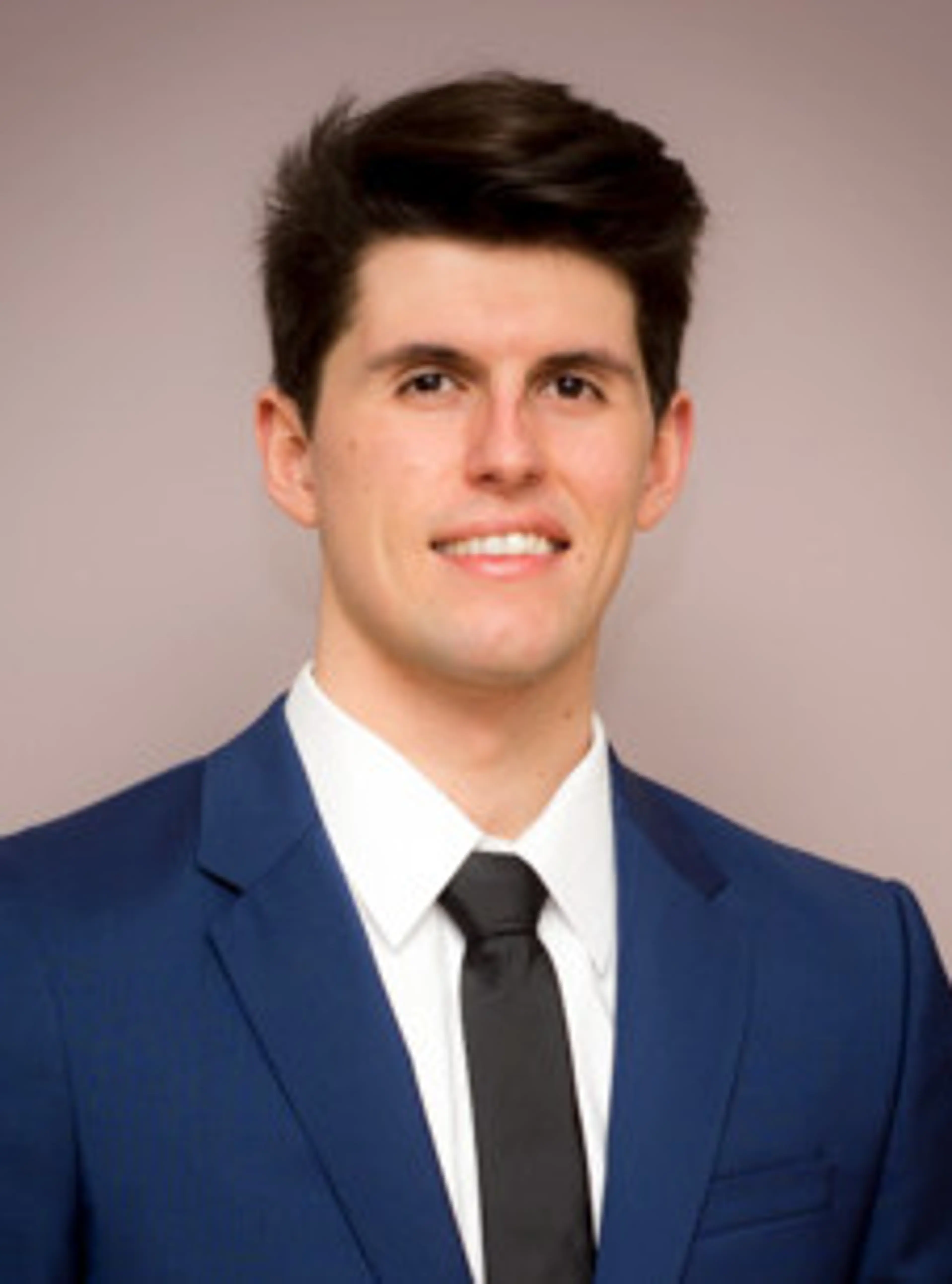 Image of a man in a blue suit, dark hair