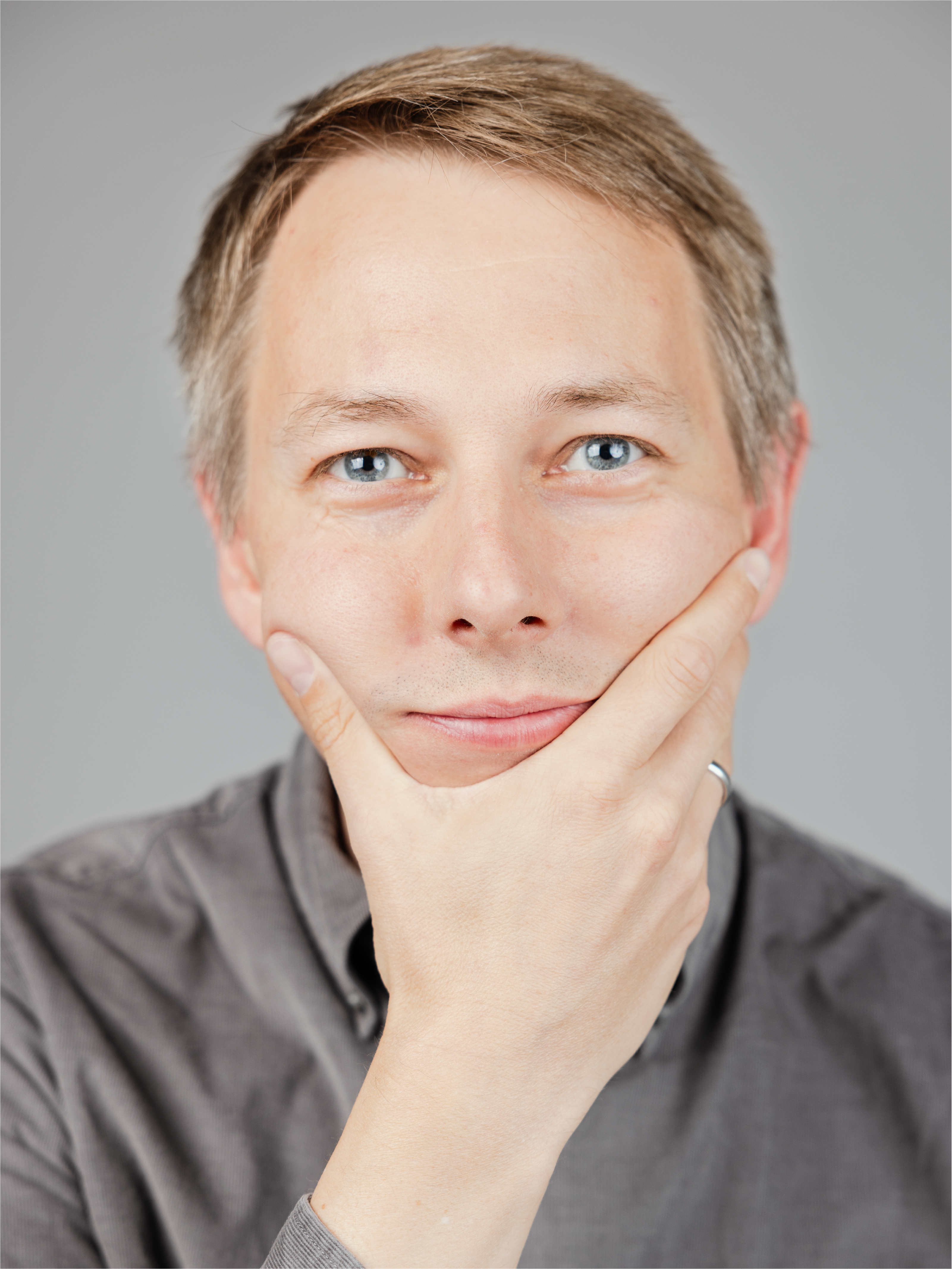 A man looking into the camera with a thoughtful pose