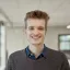 Men with sweater and jeans shirt smiling