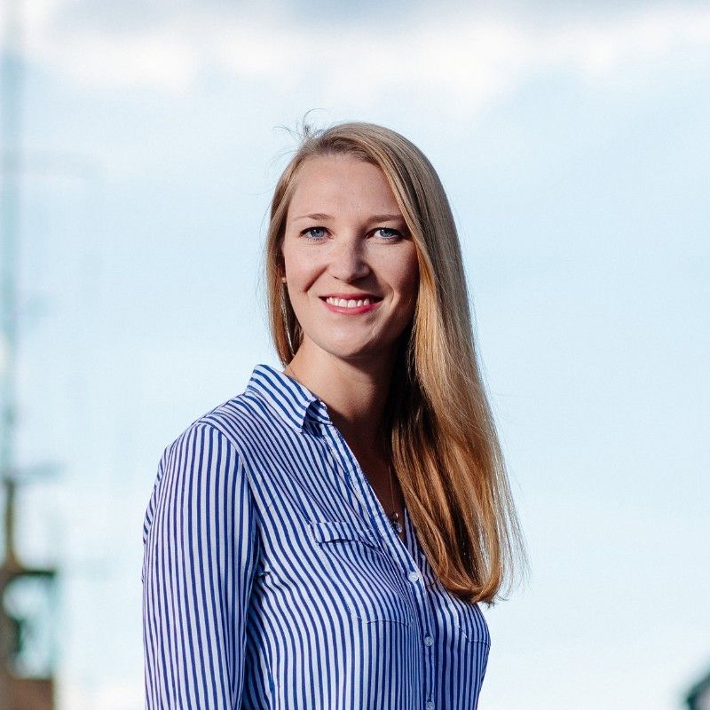 Woman wearing a blue stripe shirt.