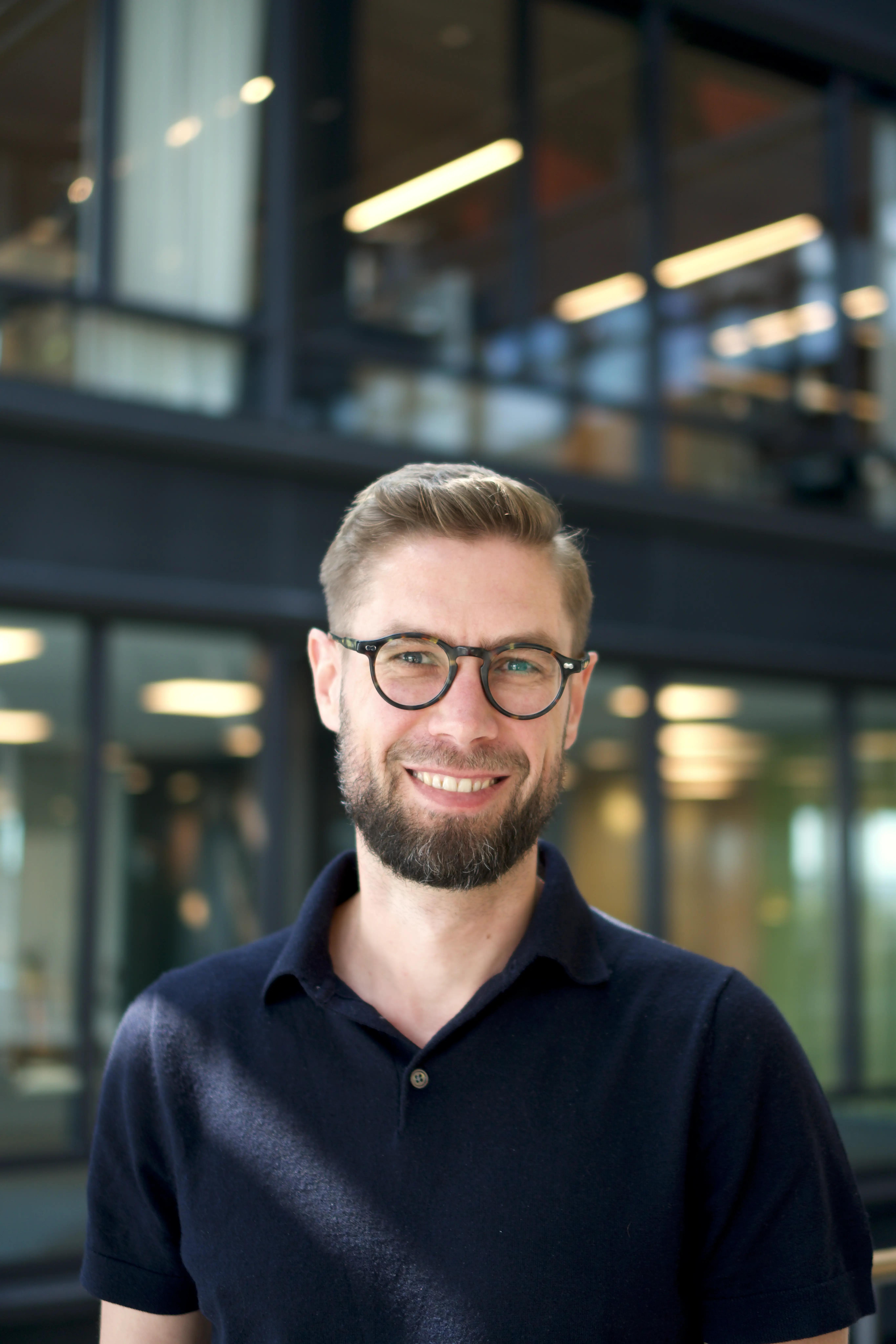 Smiling man with glasses.