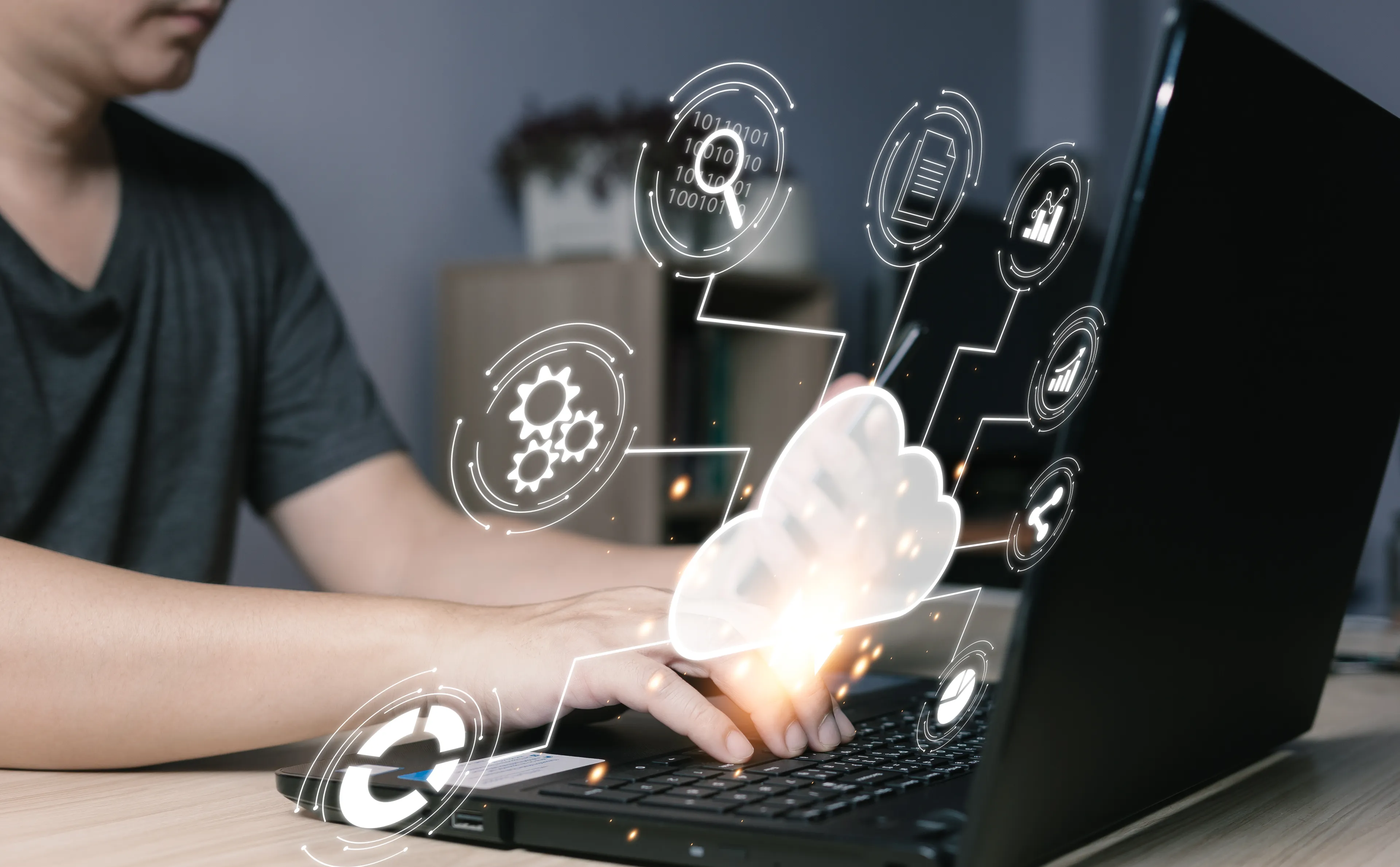 Person typing on a laptop with digital cloud computing and data technology icons overlaid, representing concepts such as cloud storage, network connectivity, and online data management.