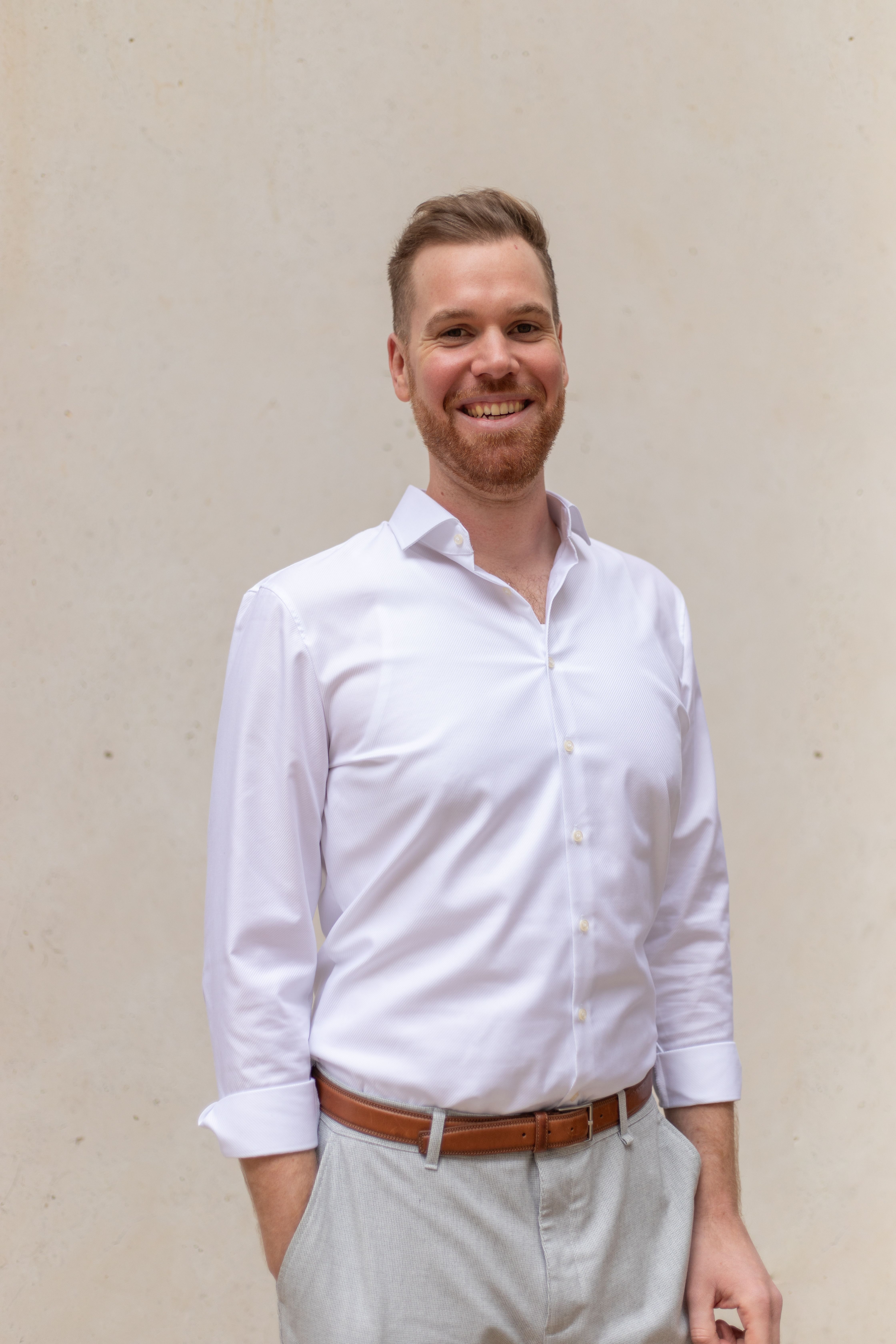 Smiling man with a white shirt.