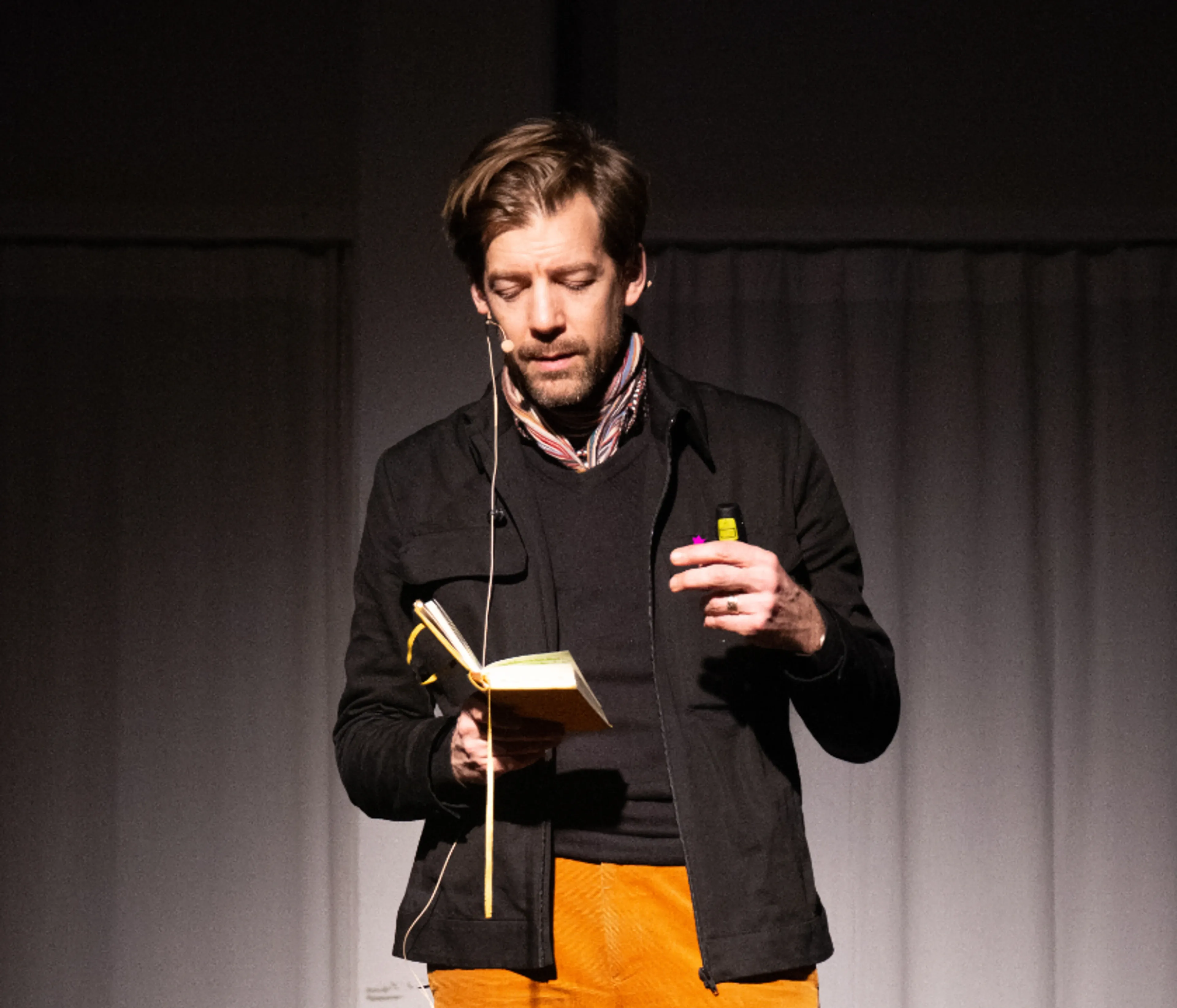 Man reading from book during presentation