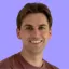 Man with red shirt smiling