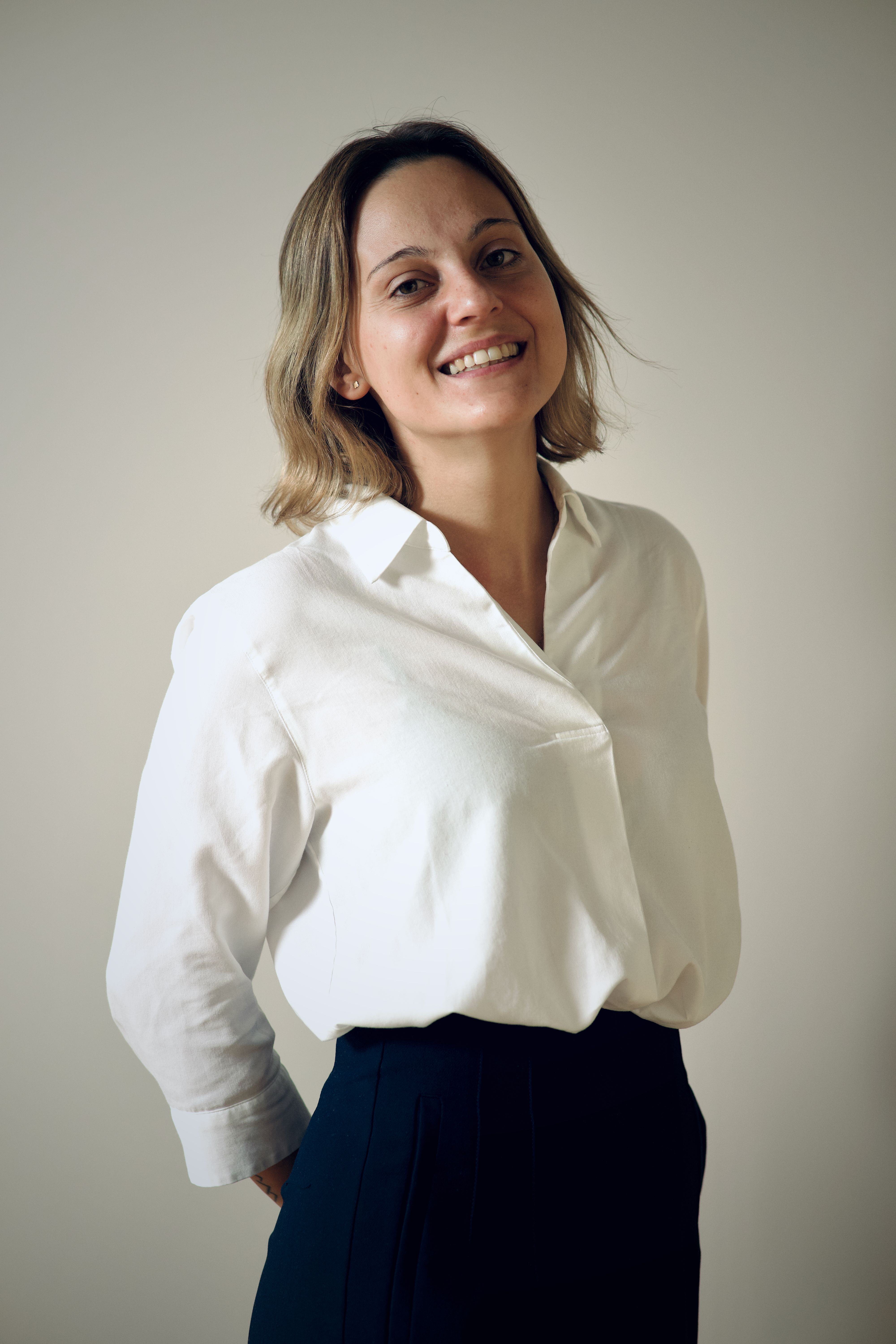 Smiling woman with a white shirt.