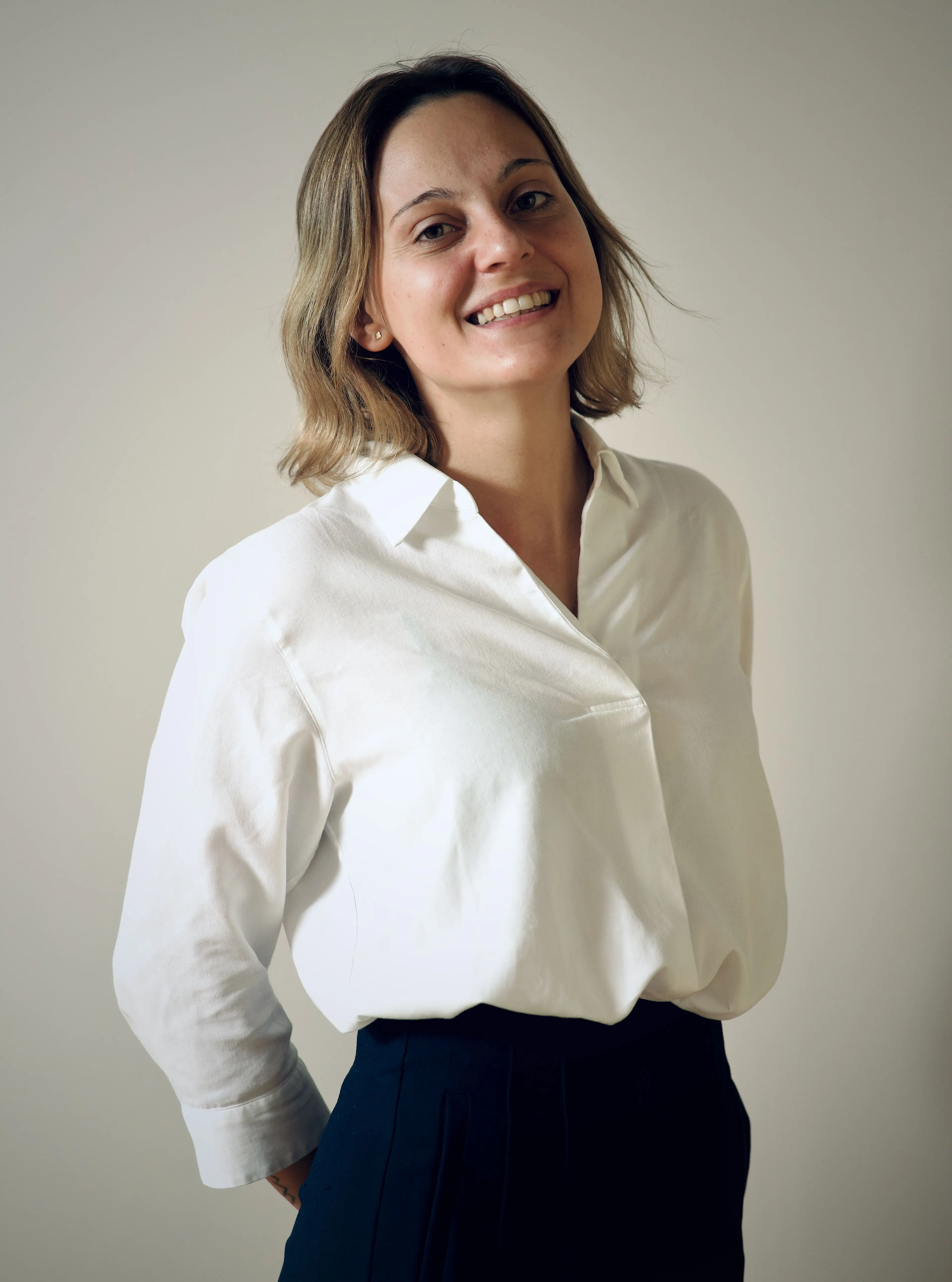 Smiling woman with a white shirt.