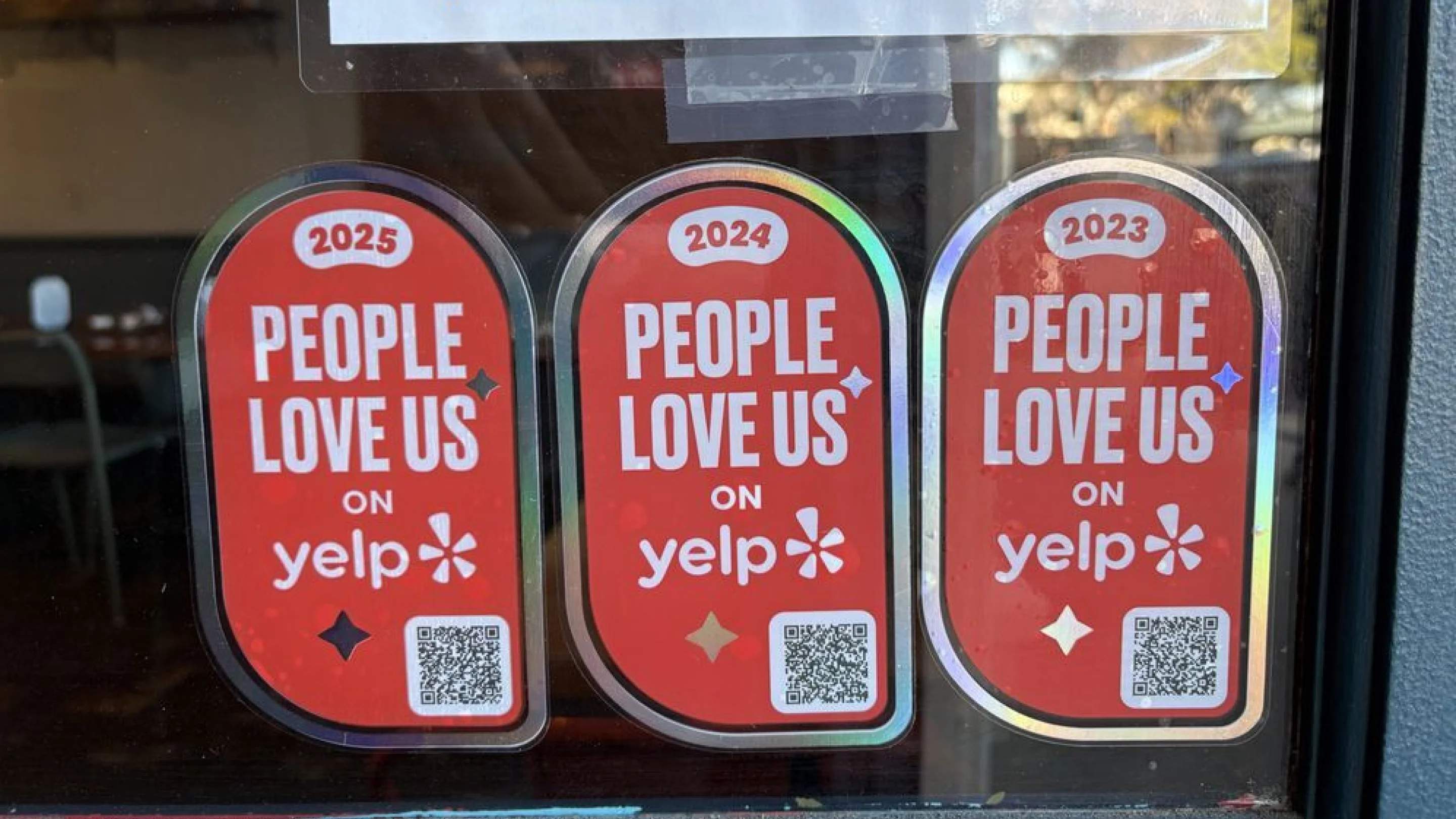 yelp review qr codes on windows of a store
