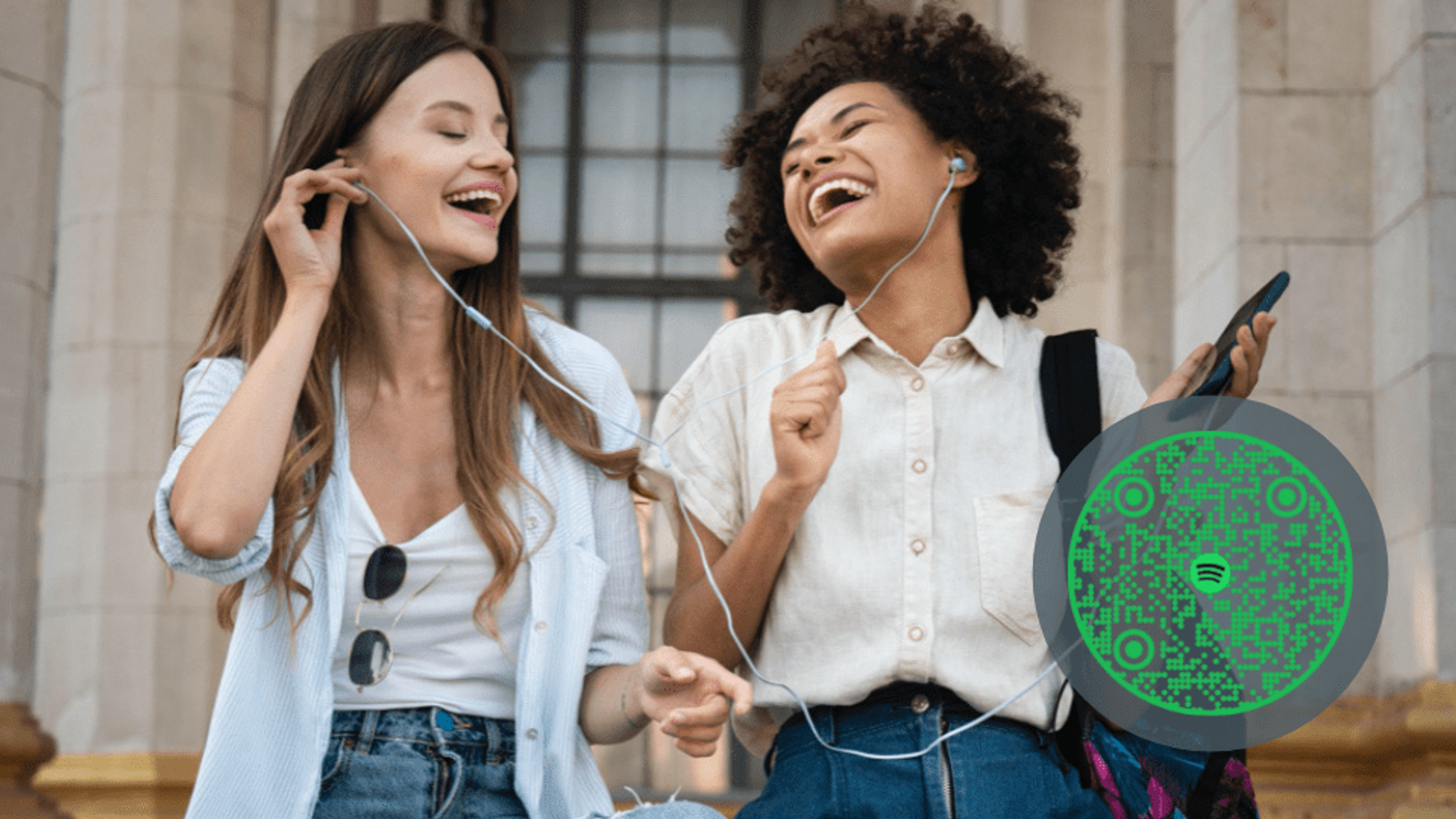 Two girls sharing music using a Spotify QR Code