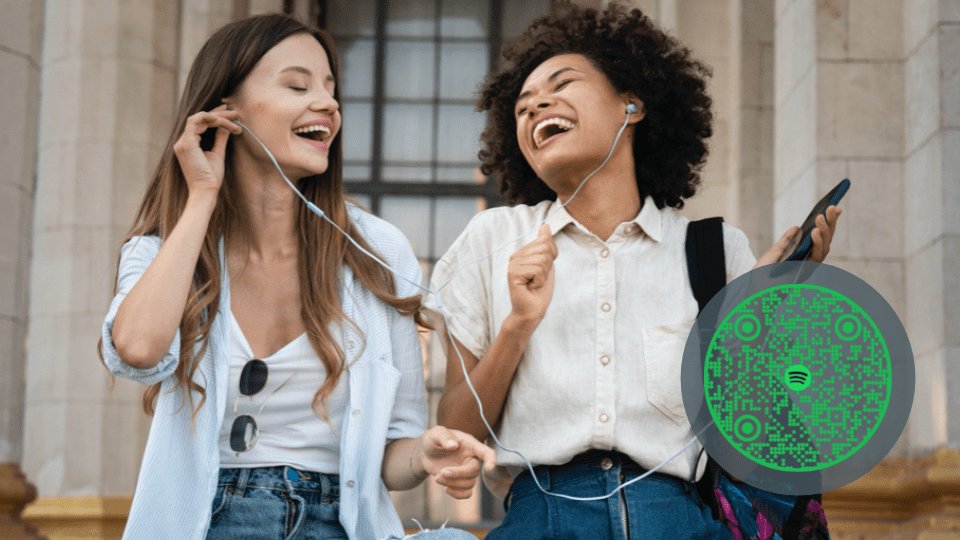 Two girls sharing music using a Spotify QR Code