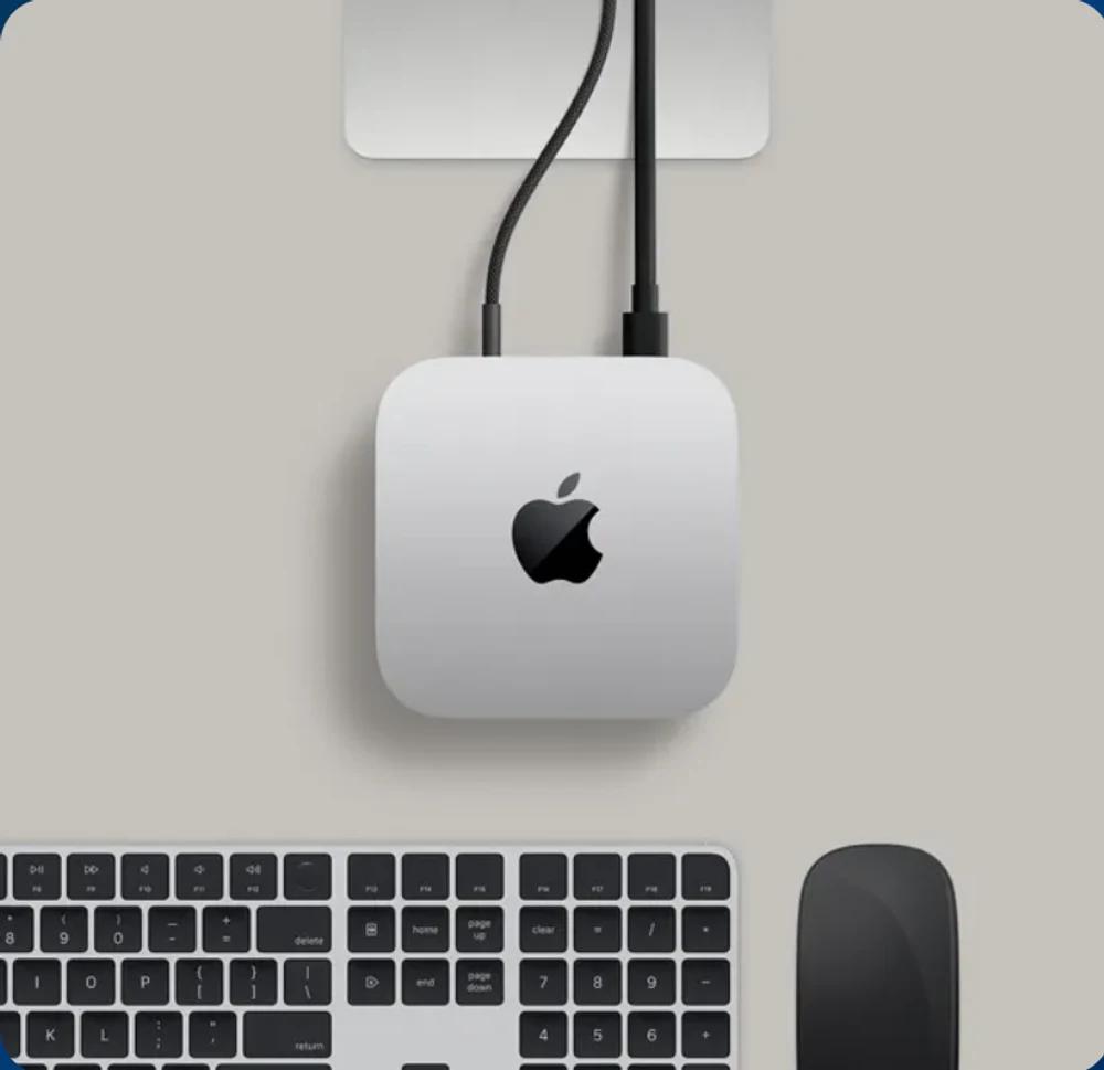 Mac Mini on a desk beside a keyboard and mouse, included in the AI Operator Kit