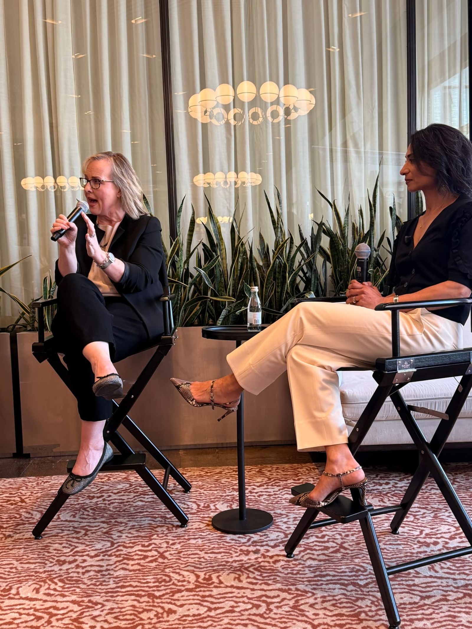 Two panelists in conversation on stage