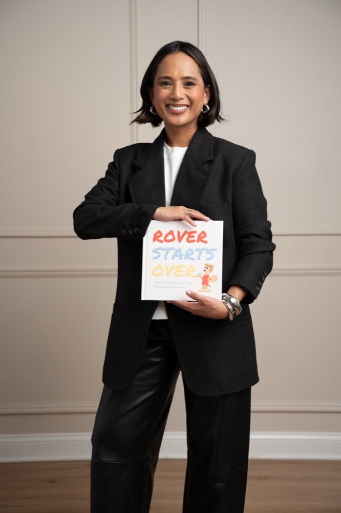 Jeanelle holding her children’s book, Rover Starts Over