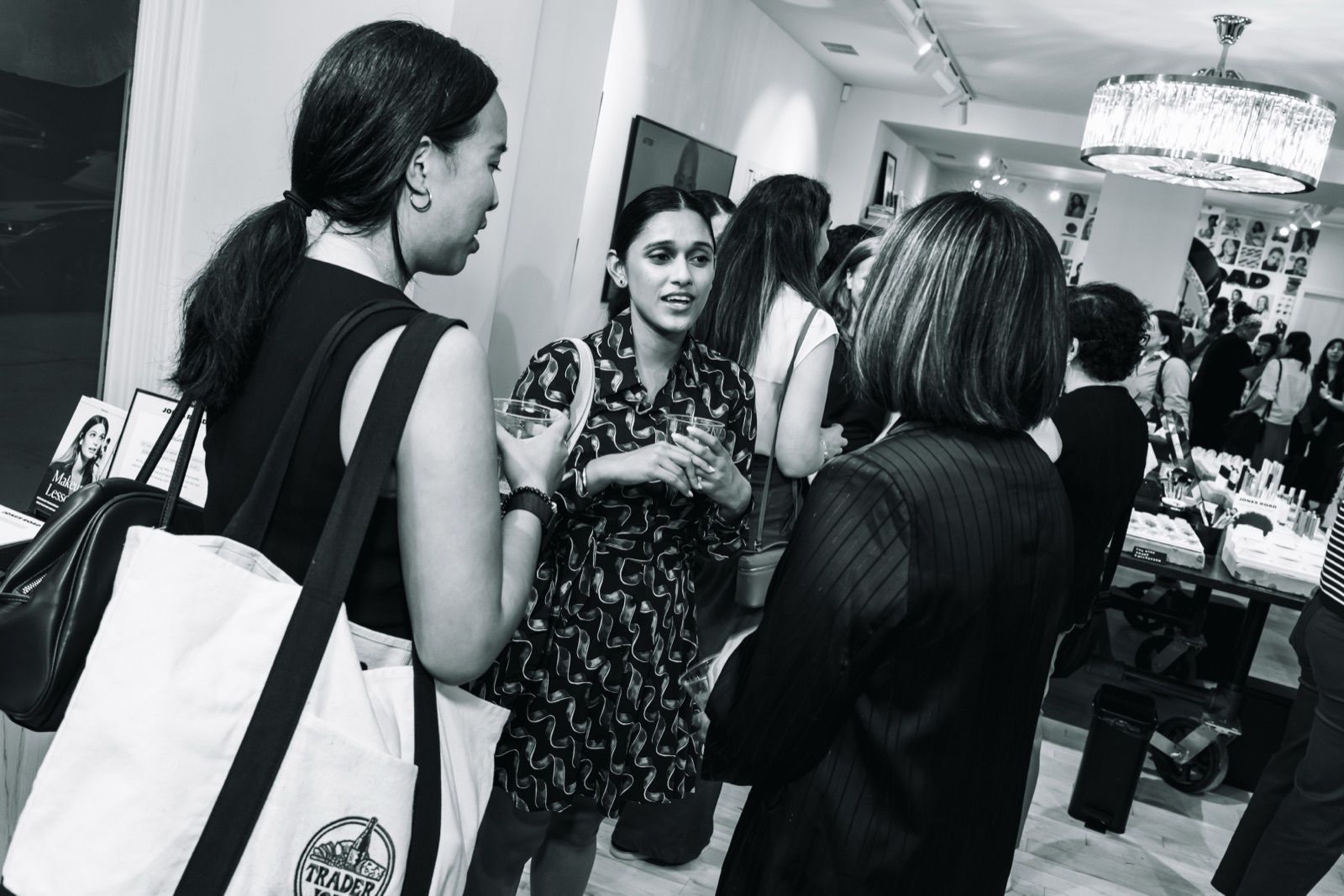 Members talking in the store with Jones Road tote bags