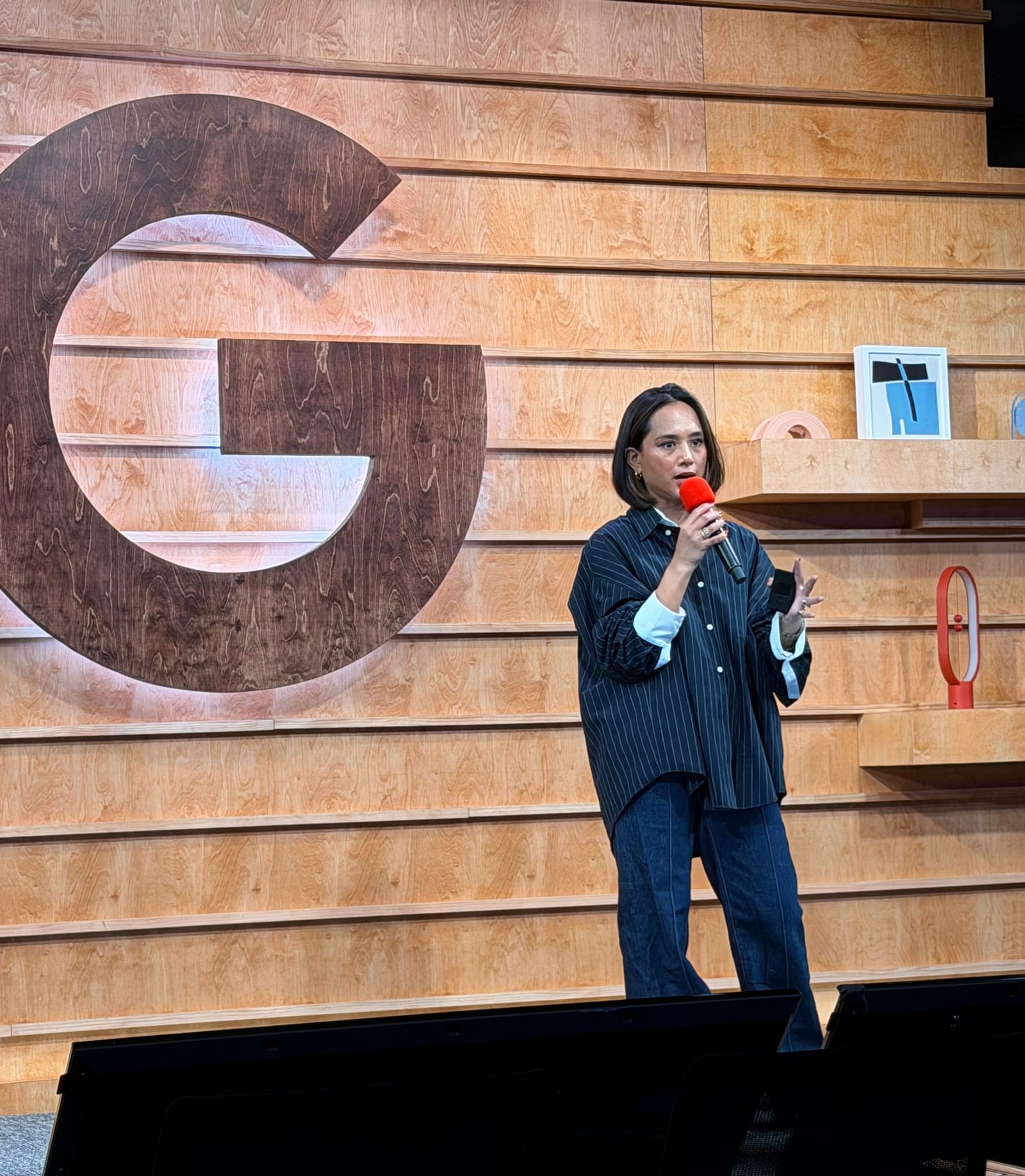 Jeanelle speaking on stage at Google
