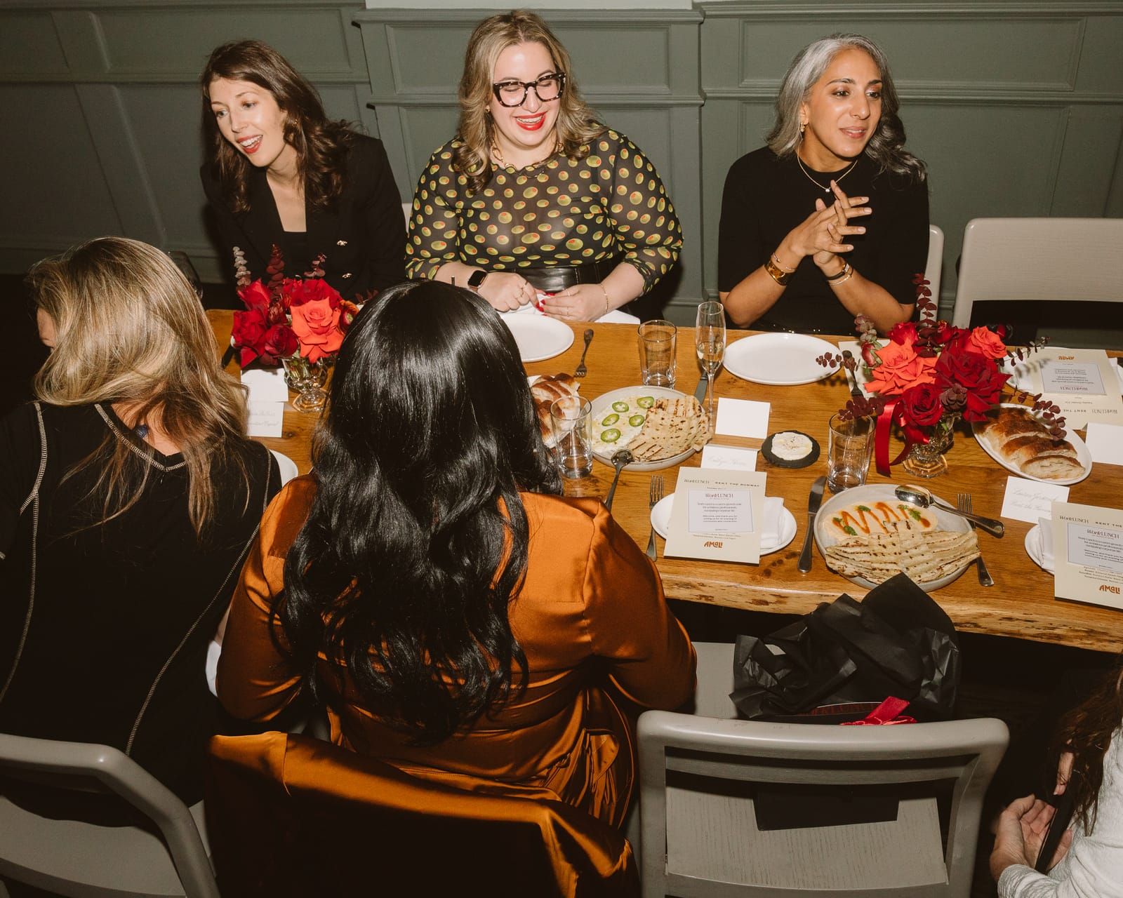 Guests talking across the table at the dinner