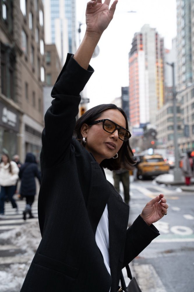 Jeanelle hailing a cab in Midtown Manhattan