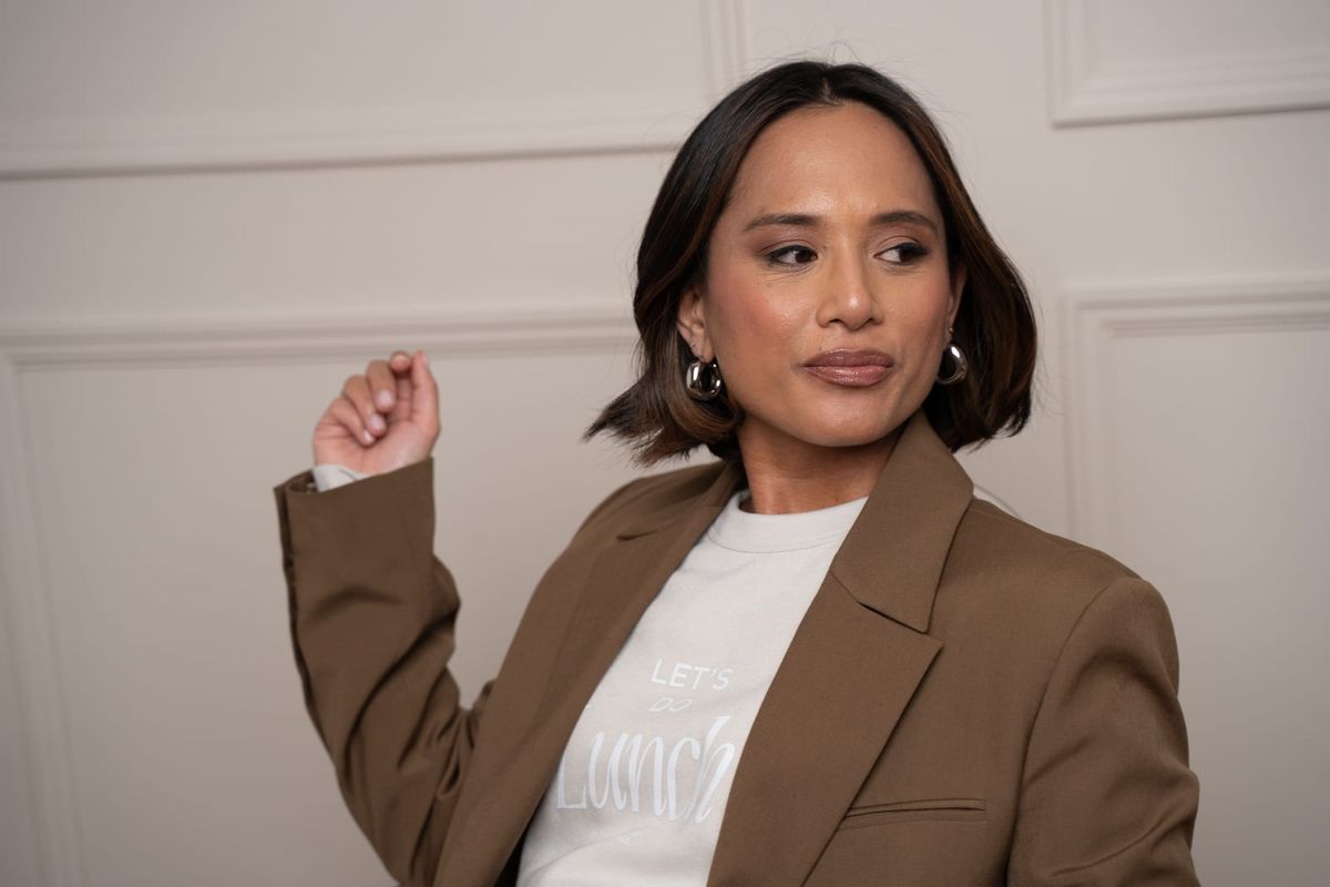 Jeanelle in a brown blazer over a white Work Lunch tee