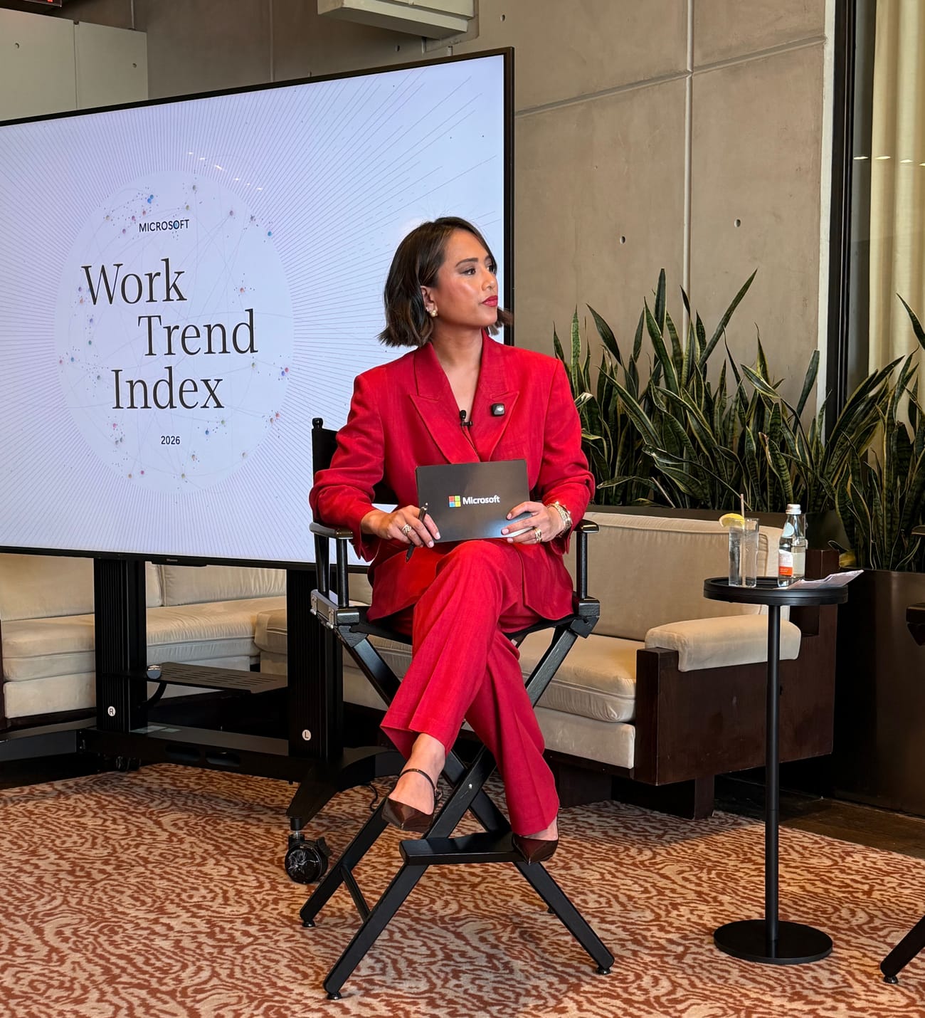 Jeanelle on stage in a red suit at the Microsoft Work Trend Index launch in New York