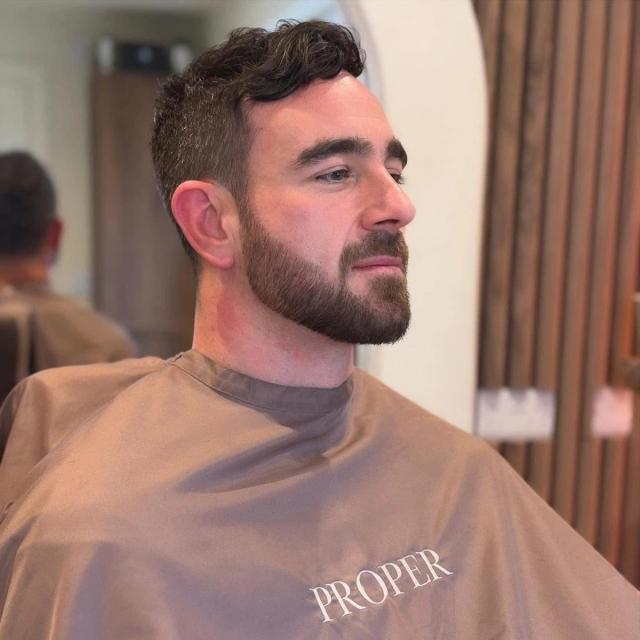 Short fade with a full, sculpted beard