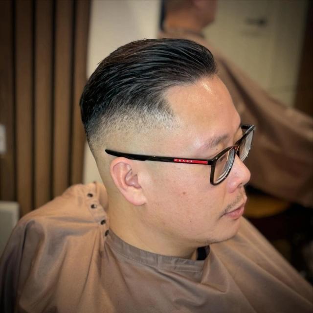 Slicked side part with a high fade