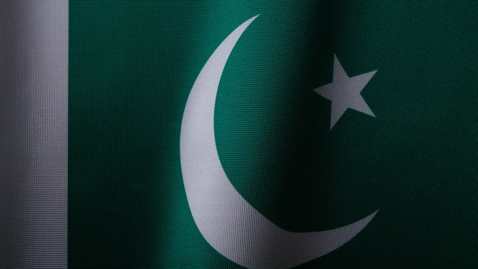 Close up of the flag of Pakistan, green with a white crescent and star