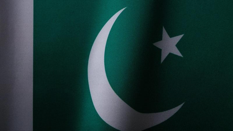 Close up of the flag of Pakistan, green with a white crescent and star