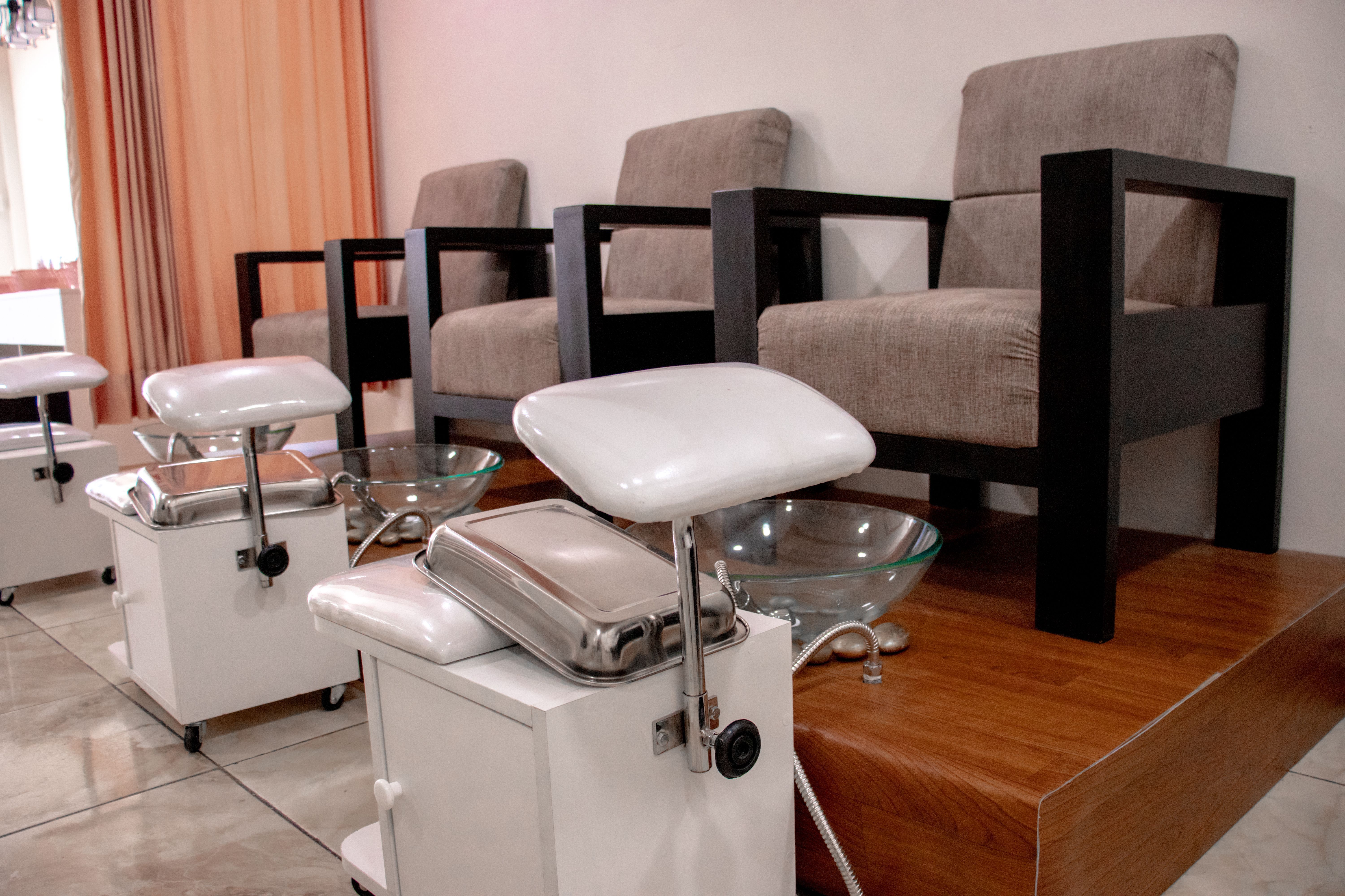 Interior of a clean, modern salon with empty styling and pedicure chairs