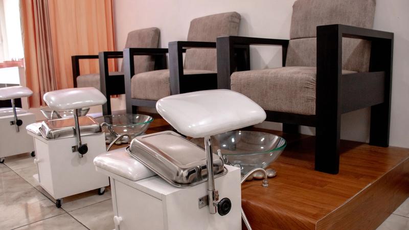 Interior of a clean, modern salon with empty styling and pedicure chairs