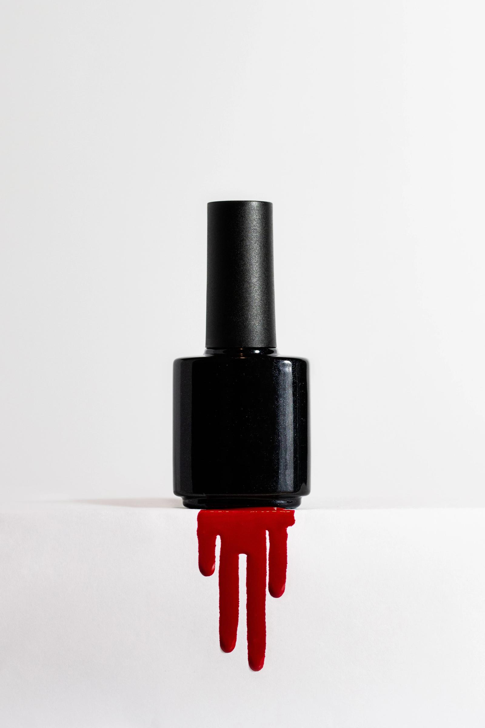 Close-up of red nail polish on a clean white background