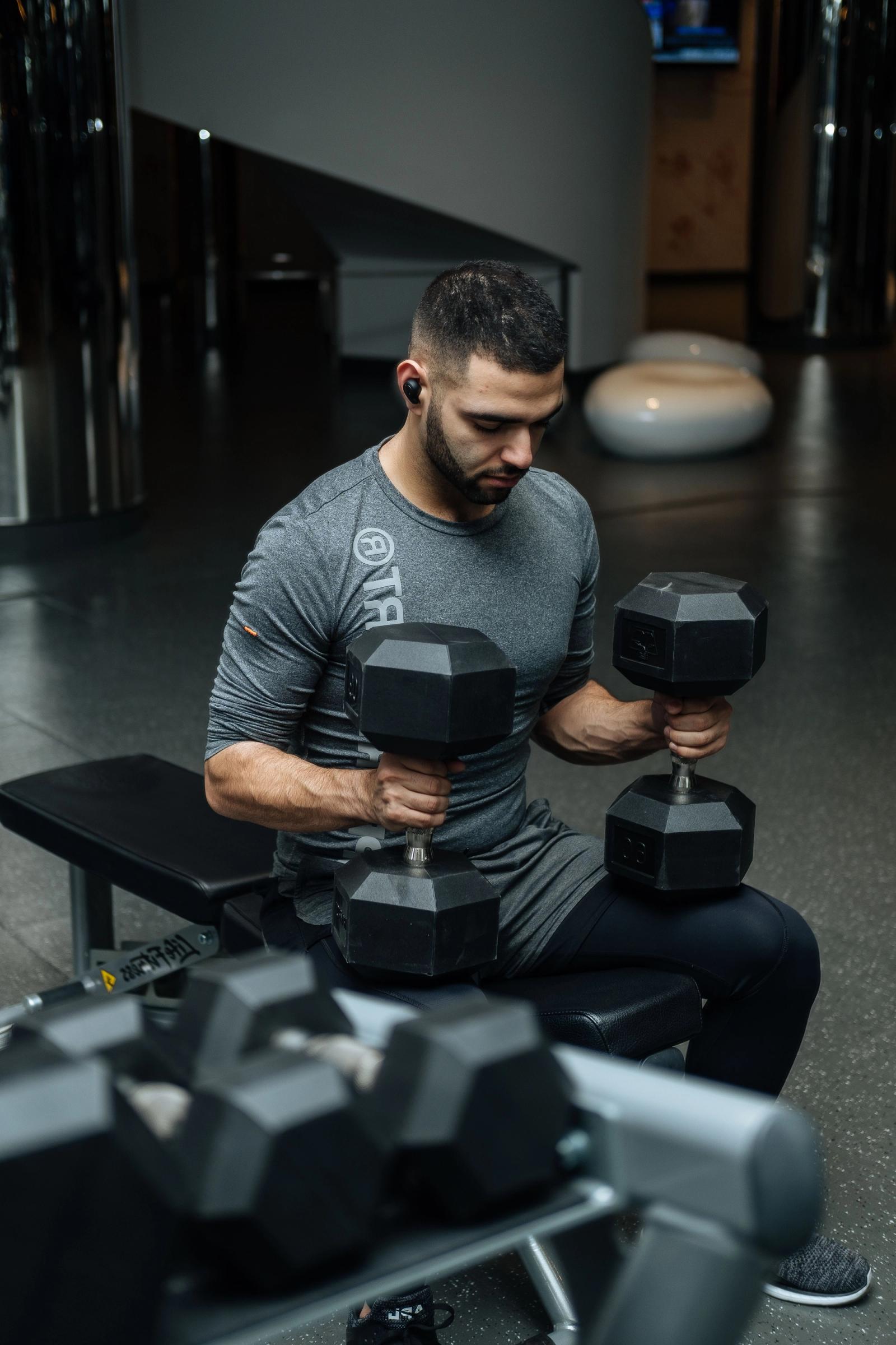 Man training with a dumbbell in a gym