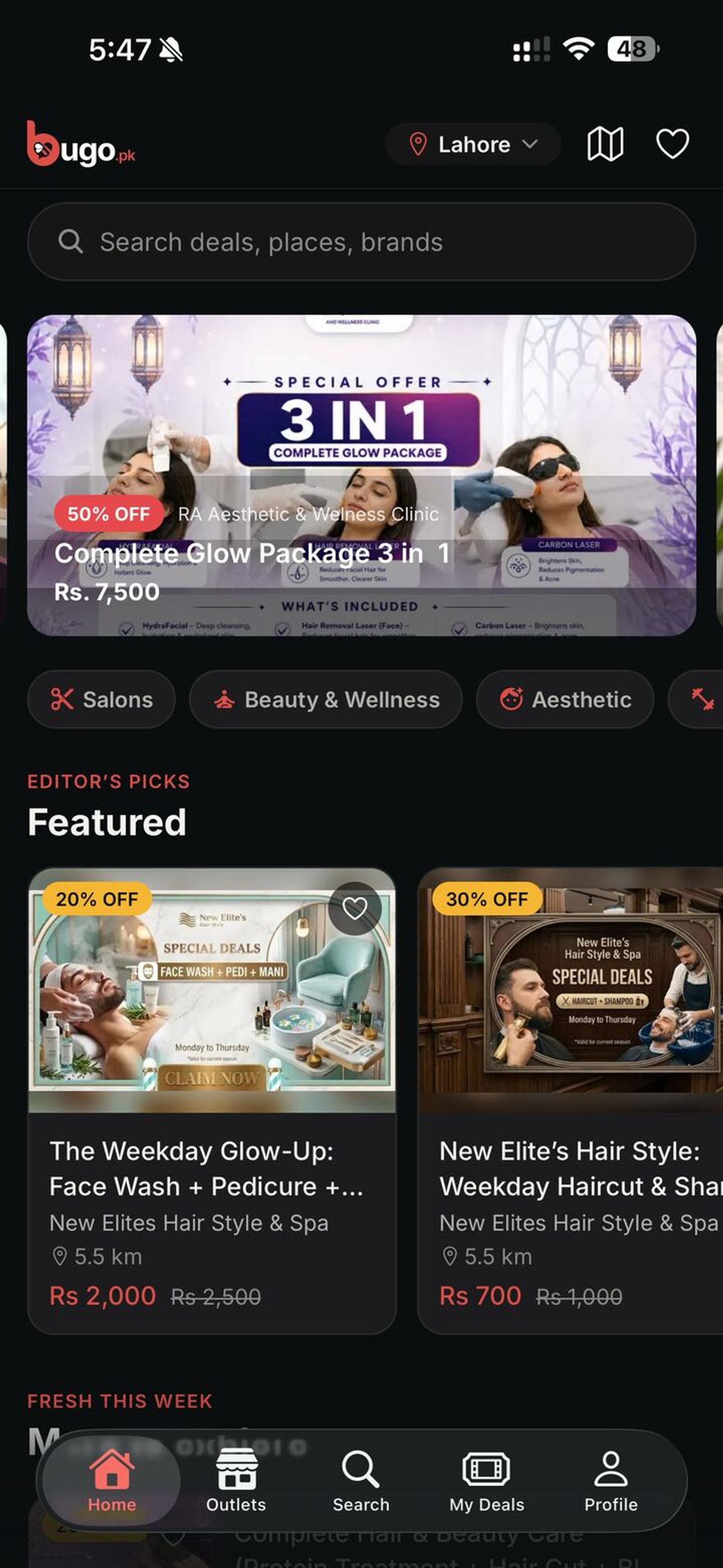 Bugo iOS app home screen in dark mode showing featured salon and aesthetic deals in Lahore