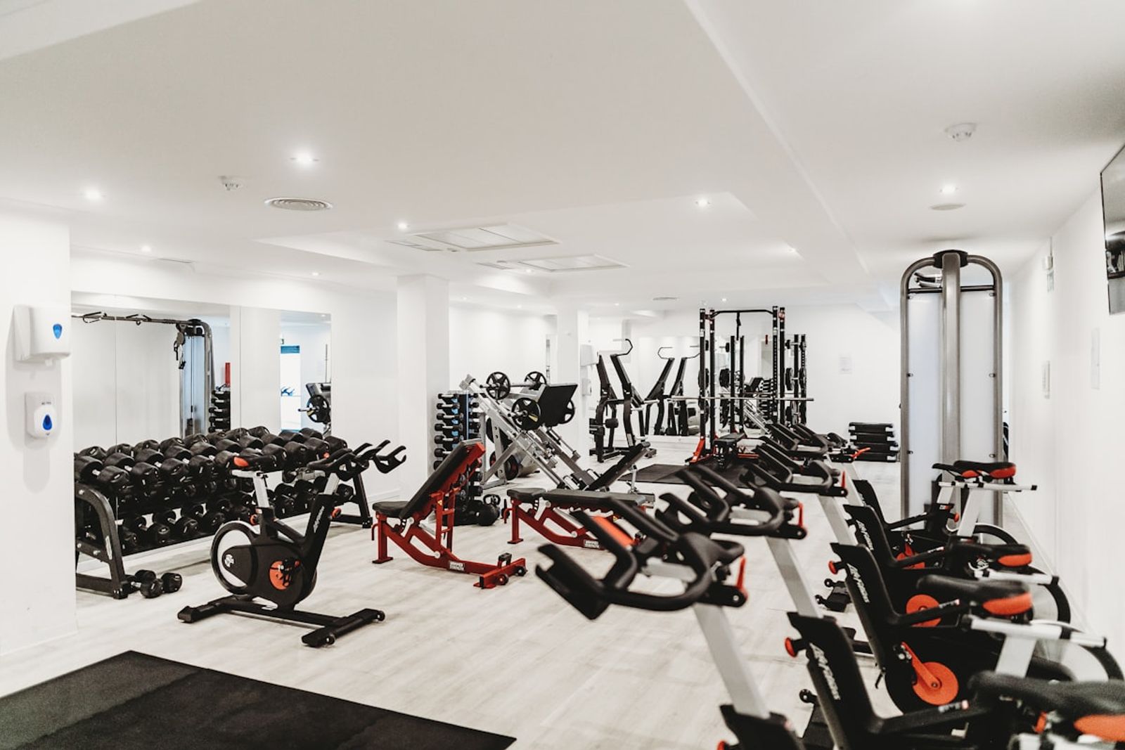 Gym floor featuring weight lifting racks and strength training machines