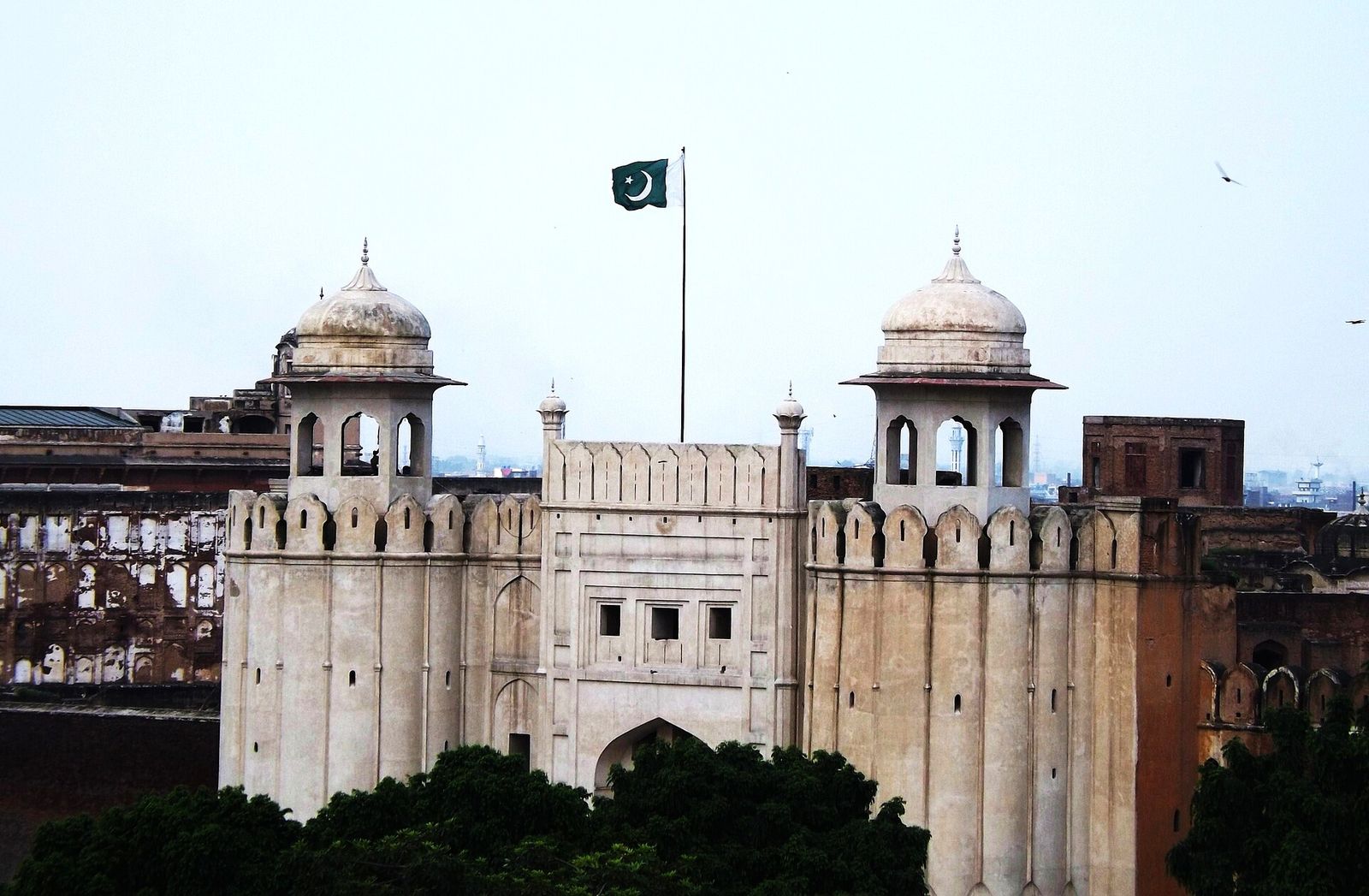 Lahore Fort seen from a rooftop in the Walled City, with the Pakistan flag flying over the gate