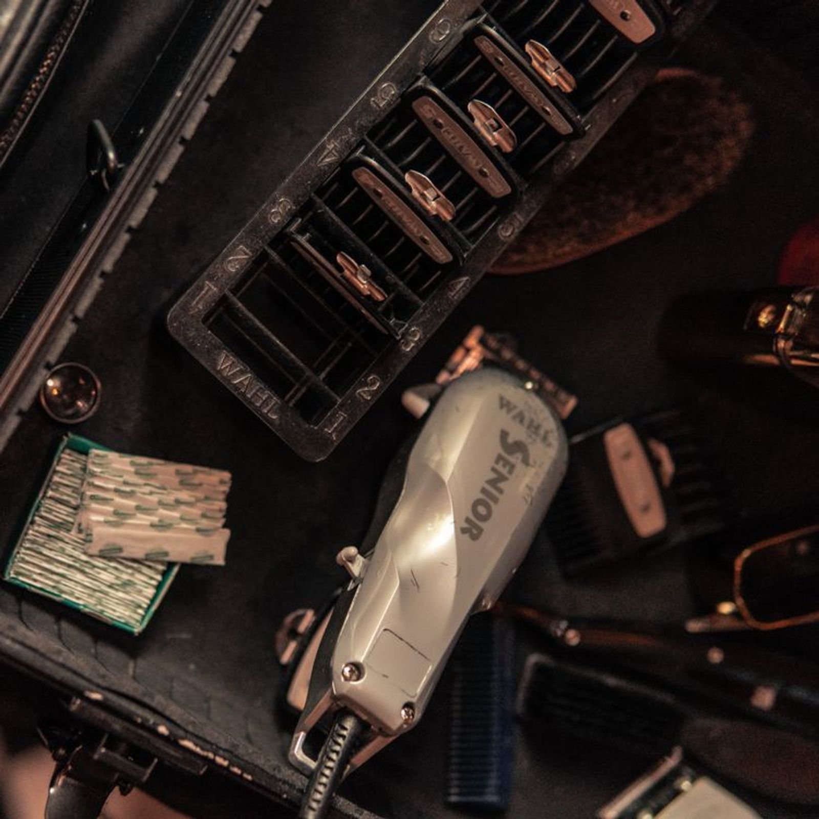 Top-down view of clean barber tools, scissors, and clippers on a workstation