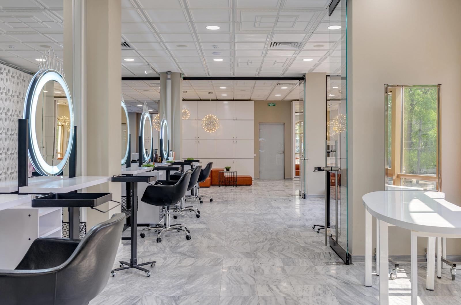 Empty modern salon interior with mirrors, styling chairs and pendant lighting