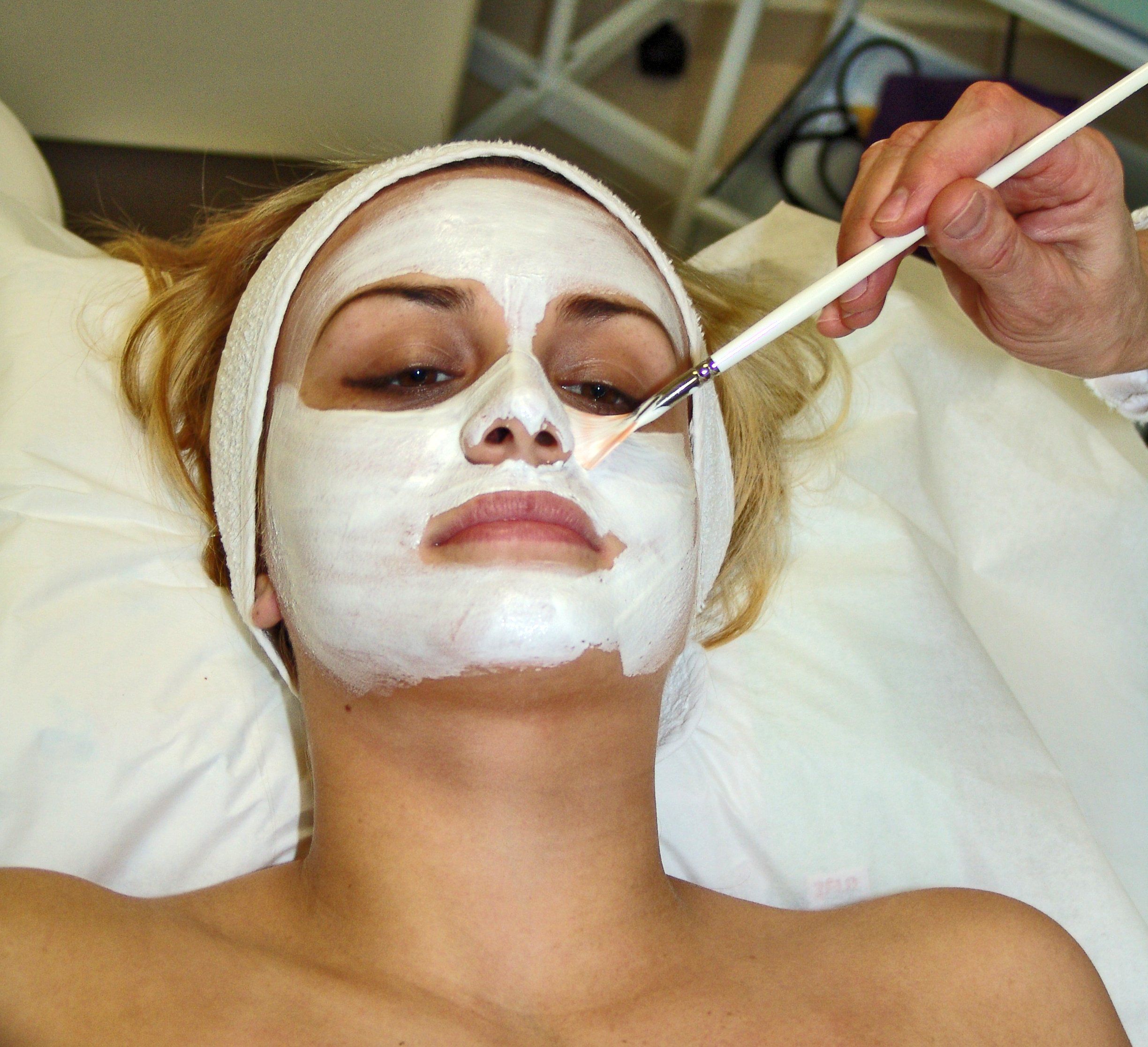 Professional facial skin care treatment and mask application in salon