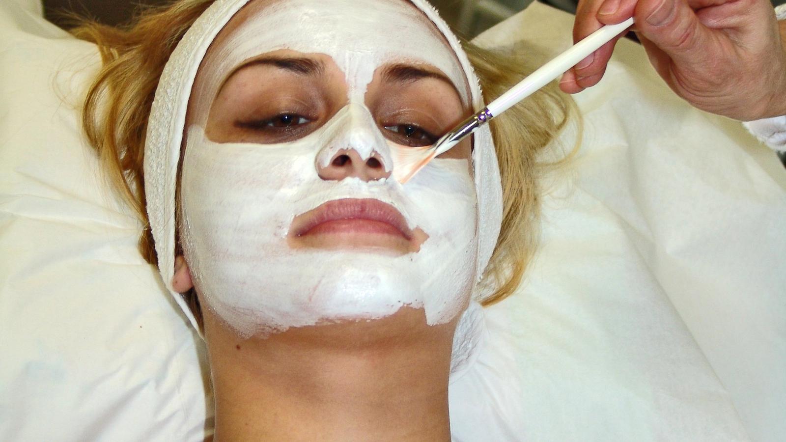 Professional facial skin care treatment and mask application in salon