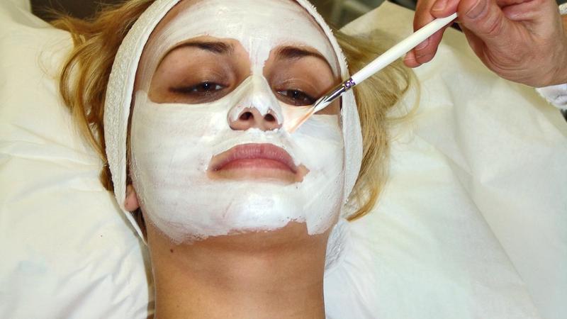 Professional facial skin care treatment and mask application in salon
