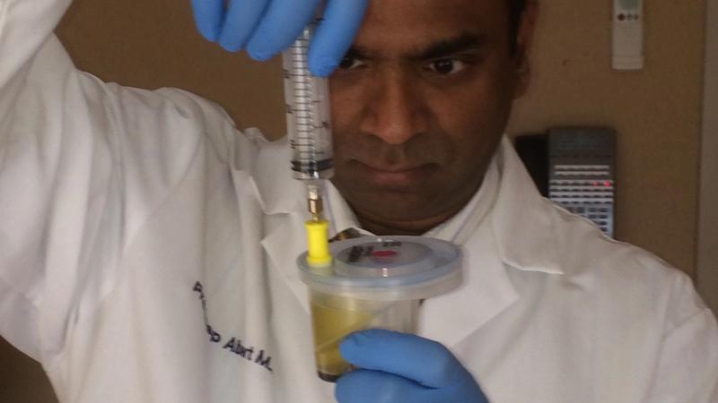 Clinical centrifuge test tube showing separated platelet-rich plasma layer above red blood cells in an aesthetic clinic lab