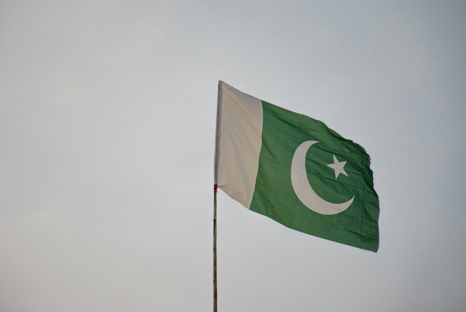 Close up of the flag of Pakistan, green with a white crescent and star