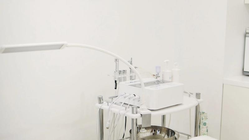 Professional skincare equipment arranged in a clean, minimalist clinic treatment room