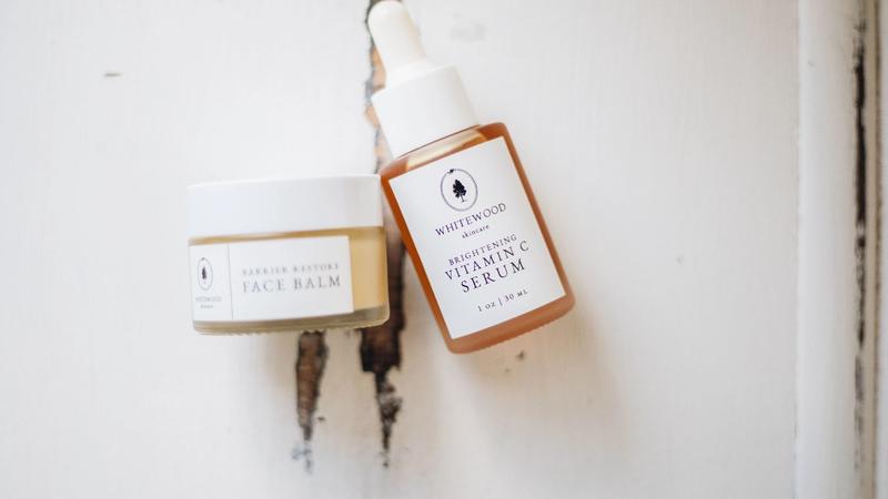 Flat lay of skincare serums and facial products arranged on a neutral surface