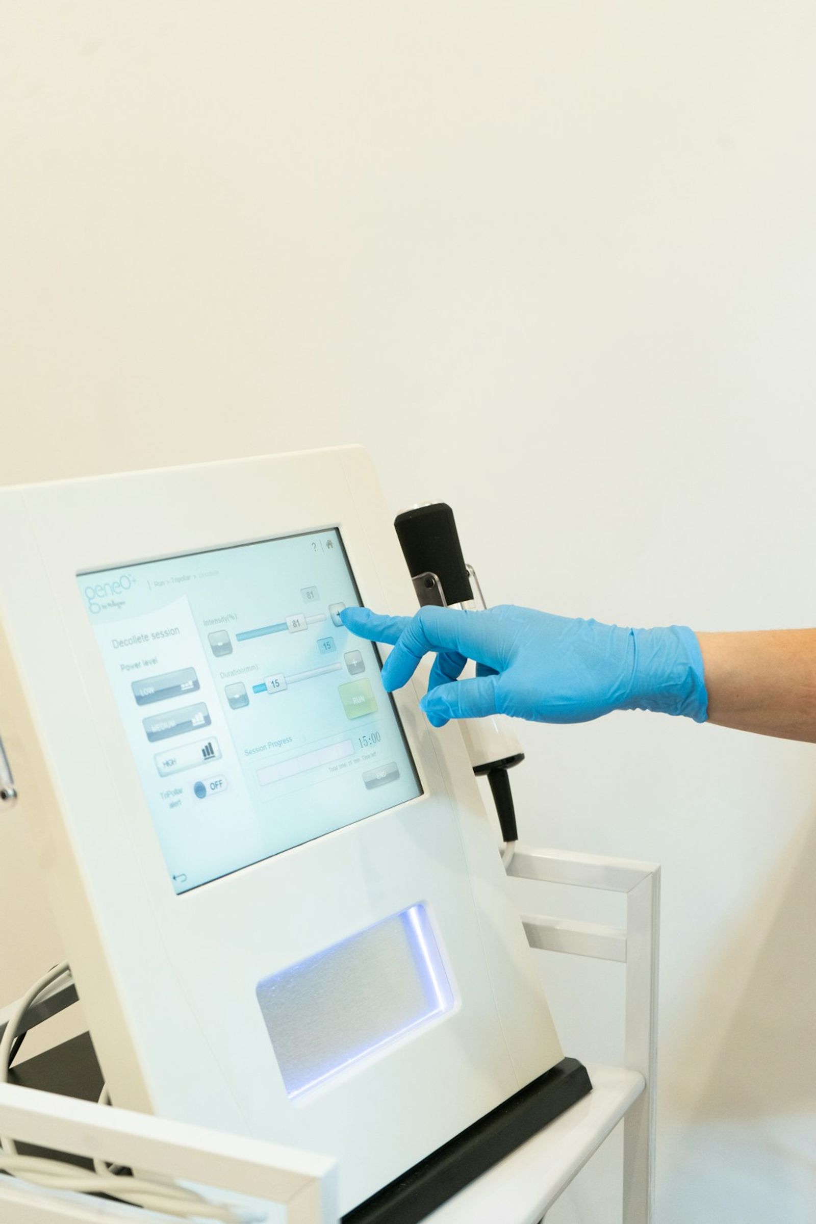 Cosmetologist operating laser treatment equipment for skin hair removal