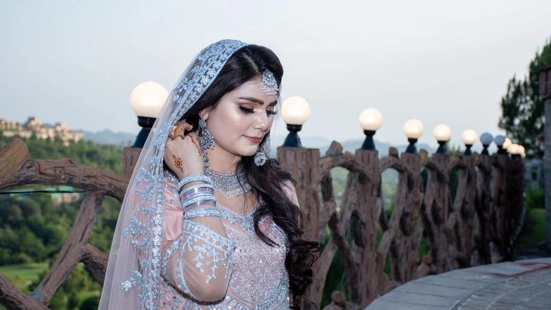 Bride in traditional Pakistani bridal wear with full bridal makeup, dupatta and jewellery